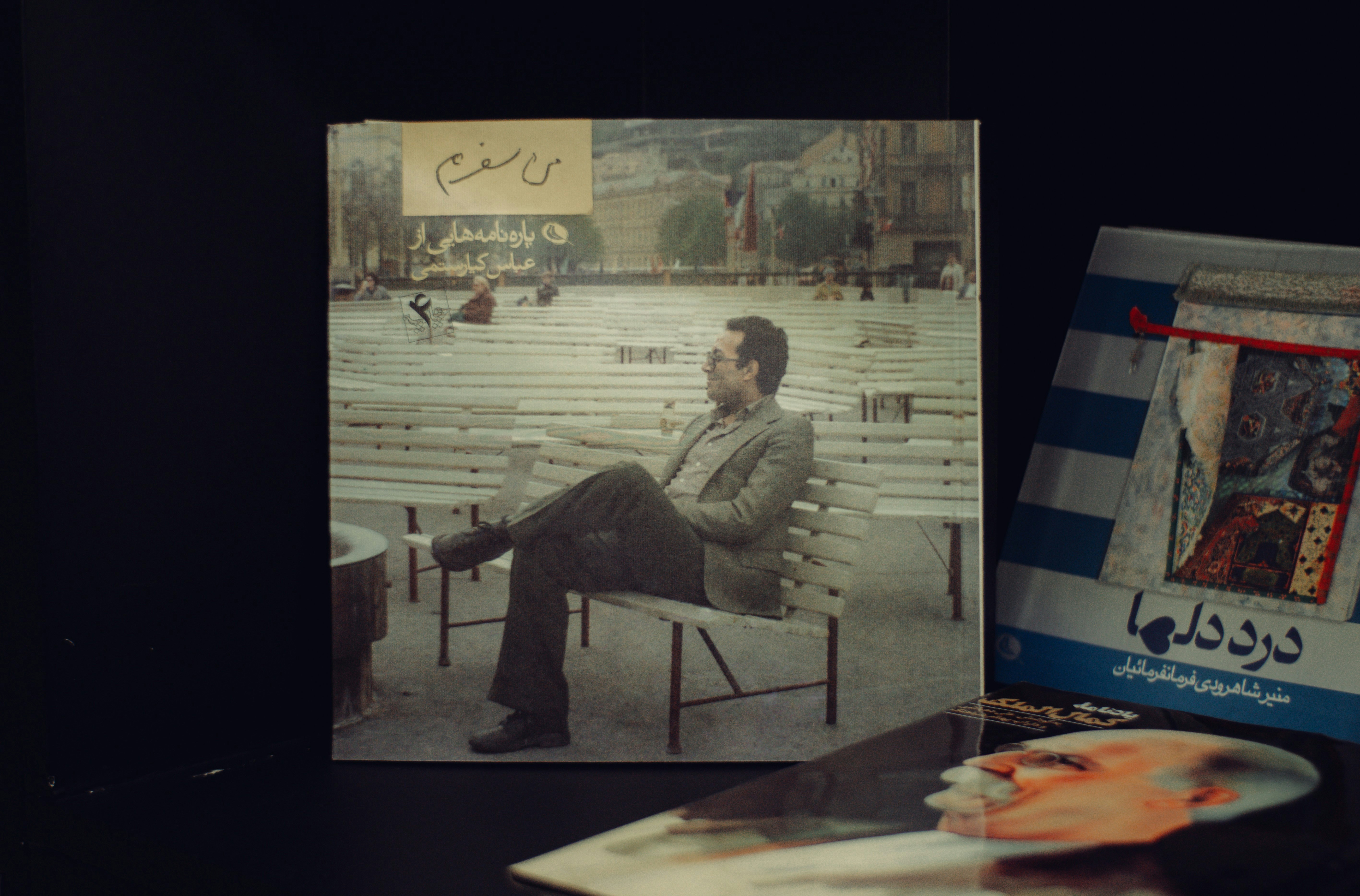 Man sitting on a bench in front of a cityscape