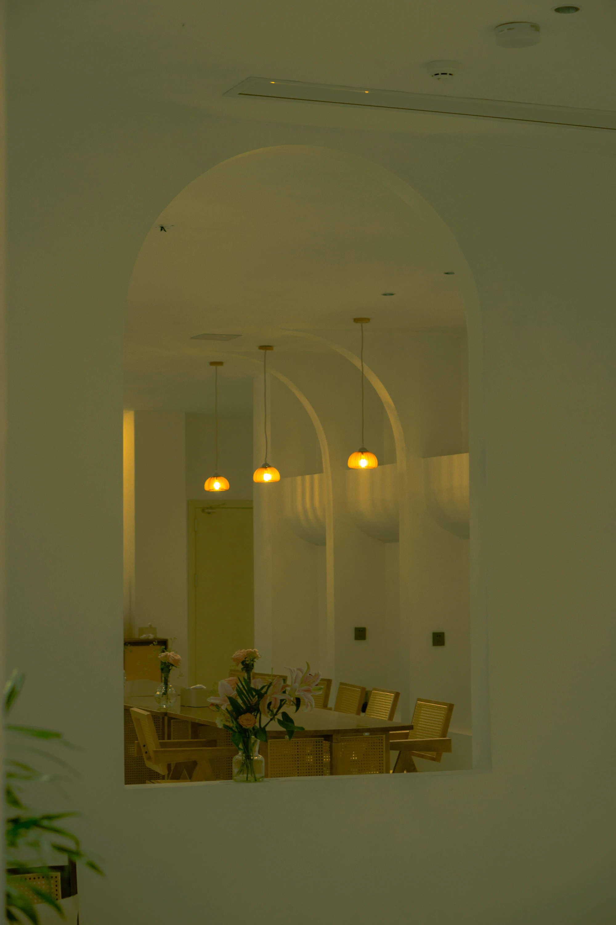 The warm, softly lit arched treatment studio