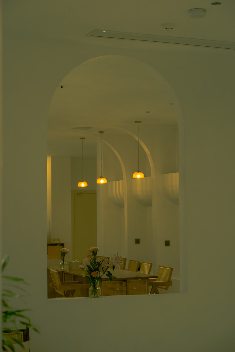 Elegant cafe interior design Jeddah Saudi Arabia   arched openings warm sage tones pendant lighting