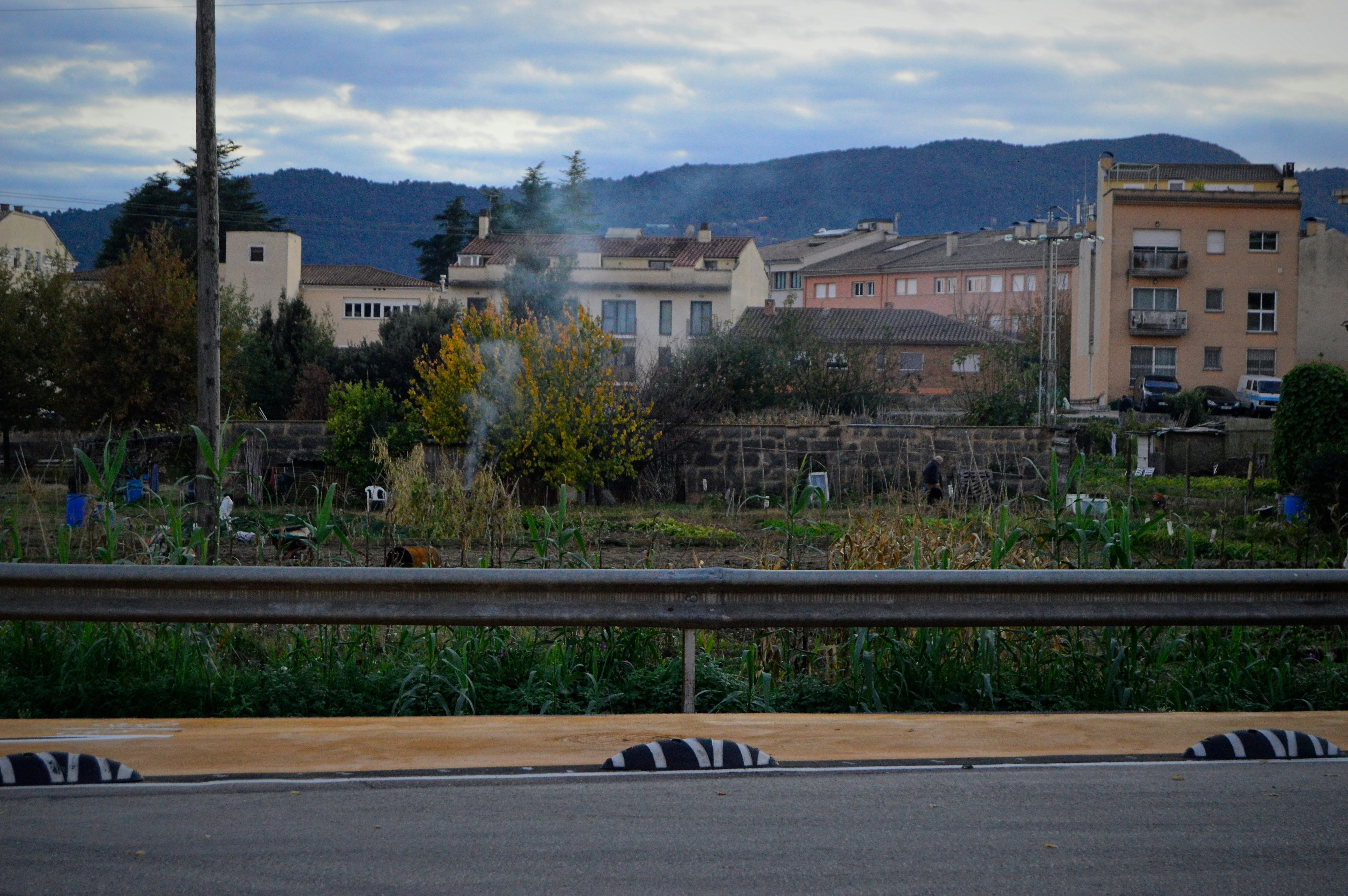 Small town with buildings and trees under cloudy sky