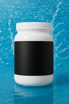 White bottle with black label on blue water