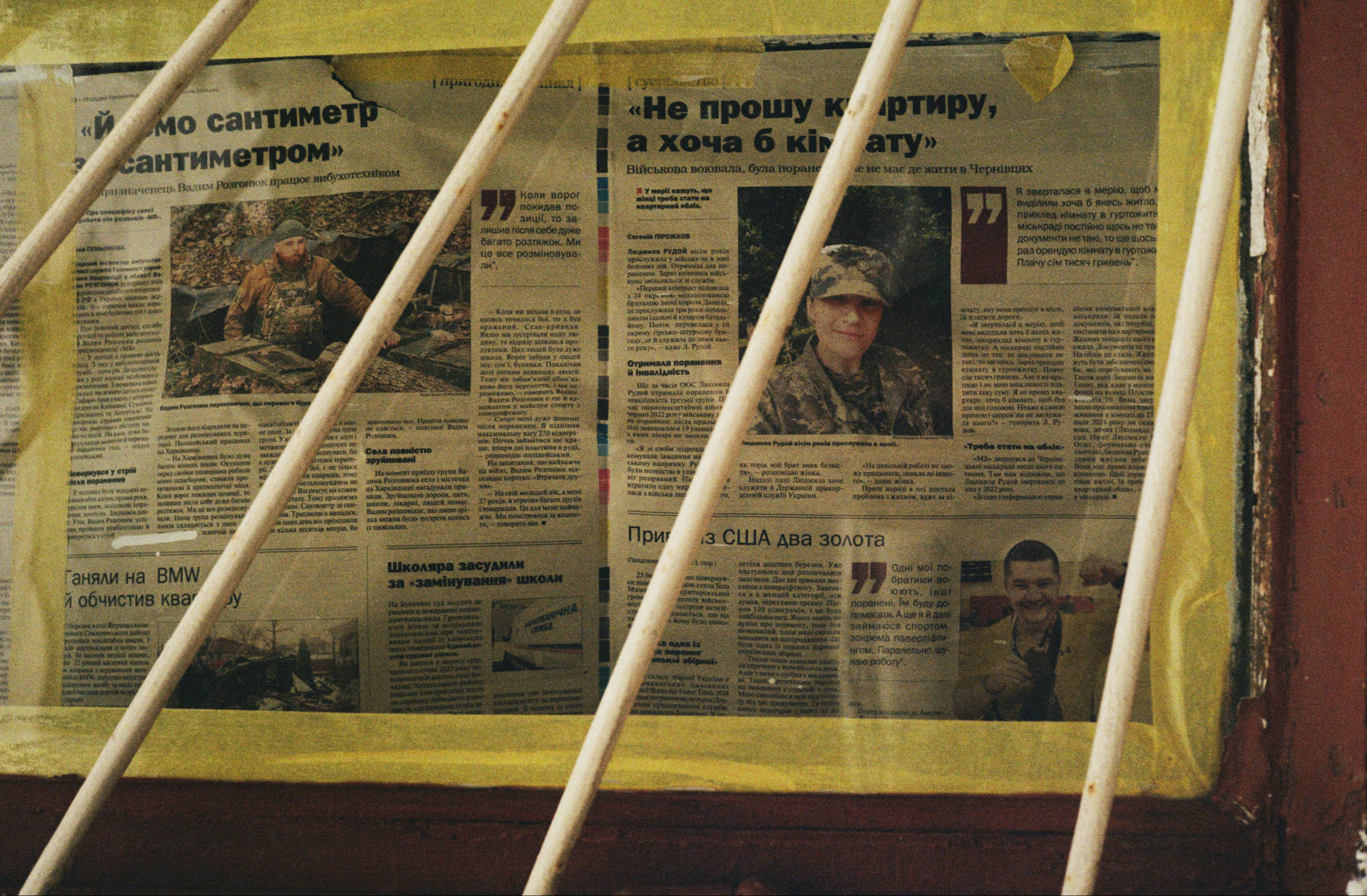 Newspaper articles displayed behind bars