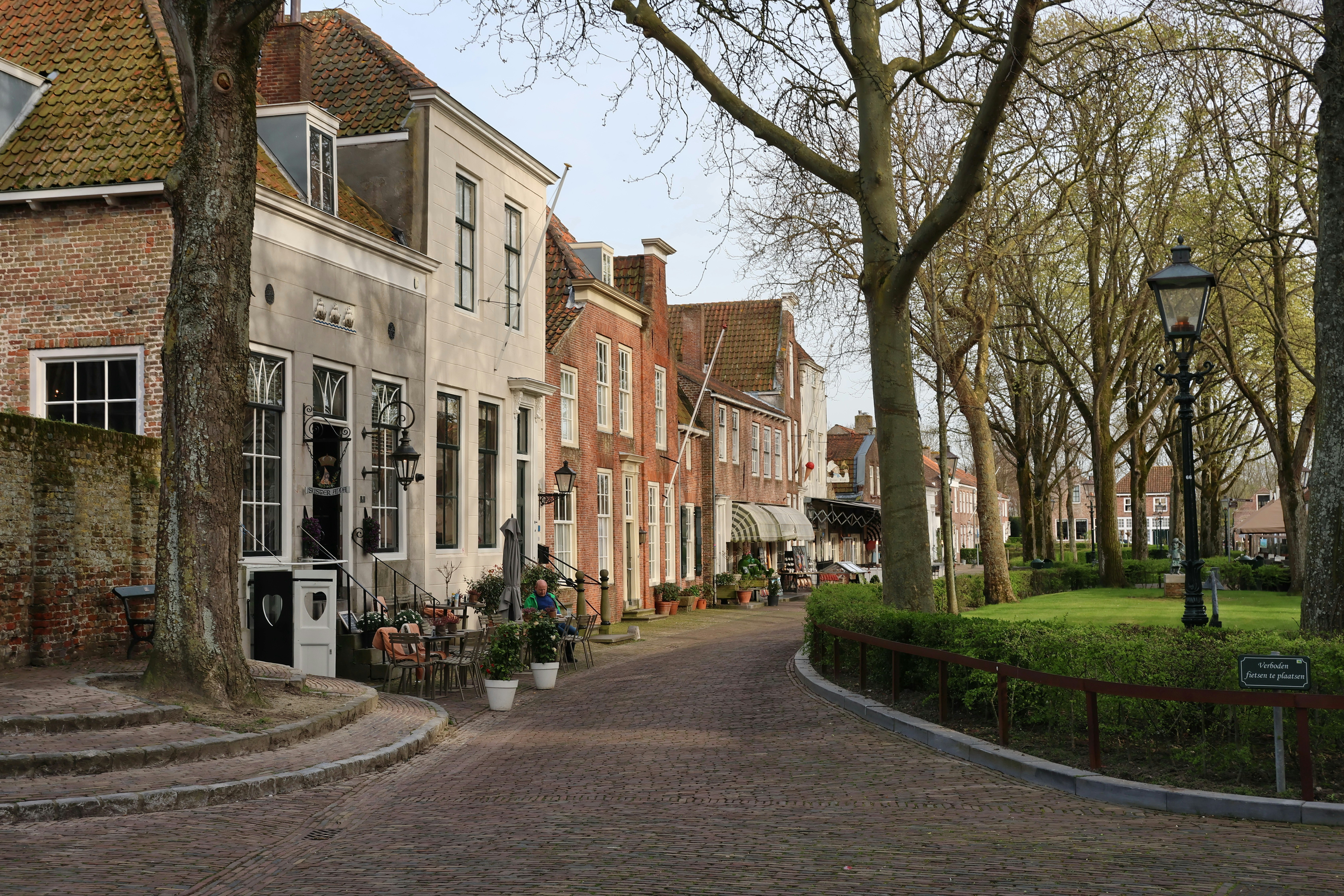 A quaint street lined with historic buildings and trees.