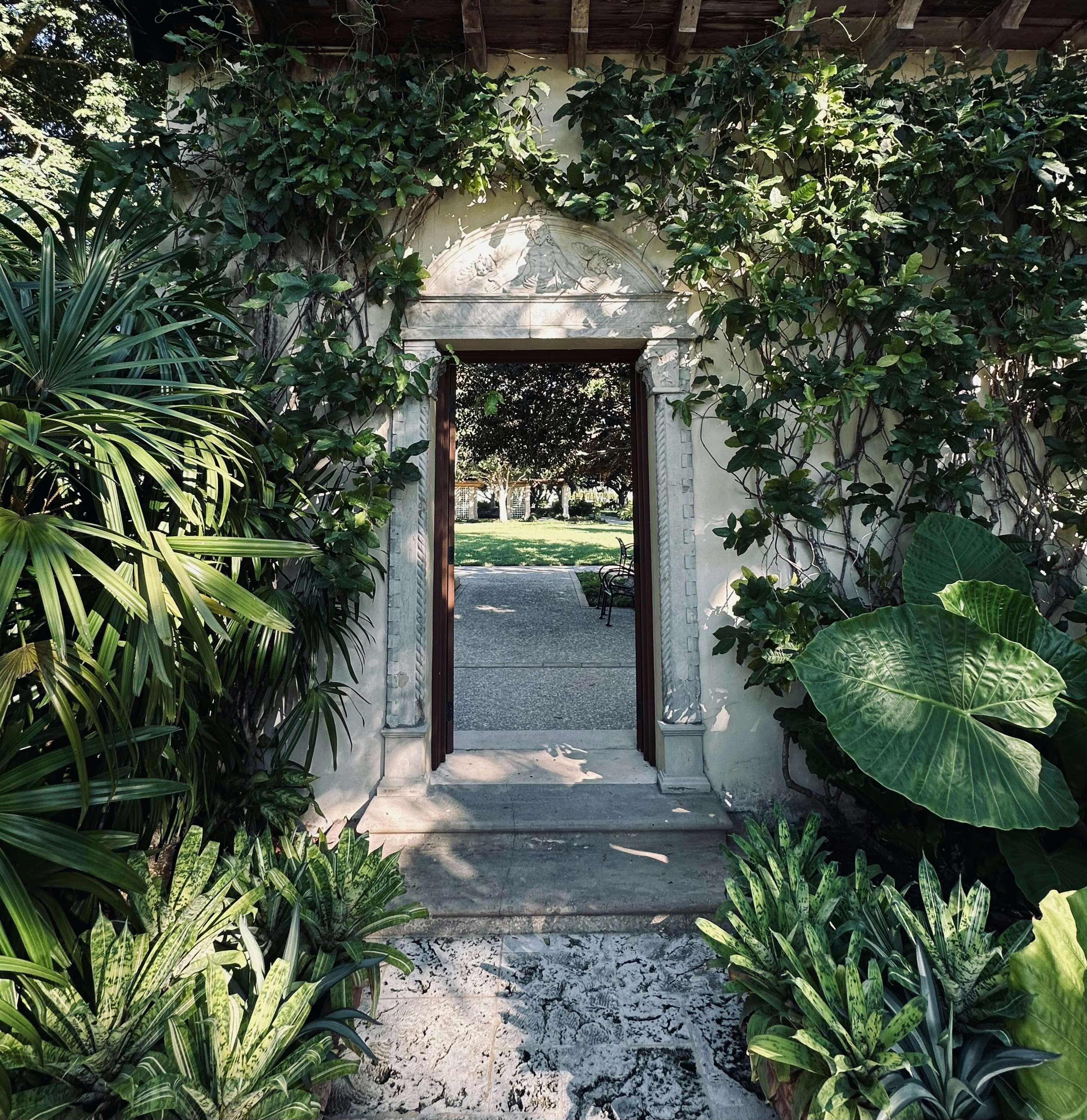 Stone archway leading to a lush green garden