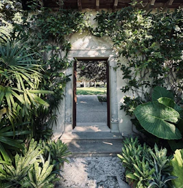 Stone archway leading to a lush green garden