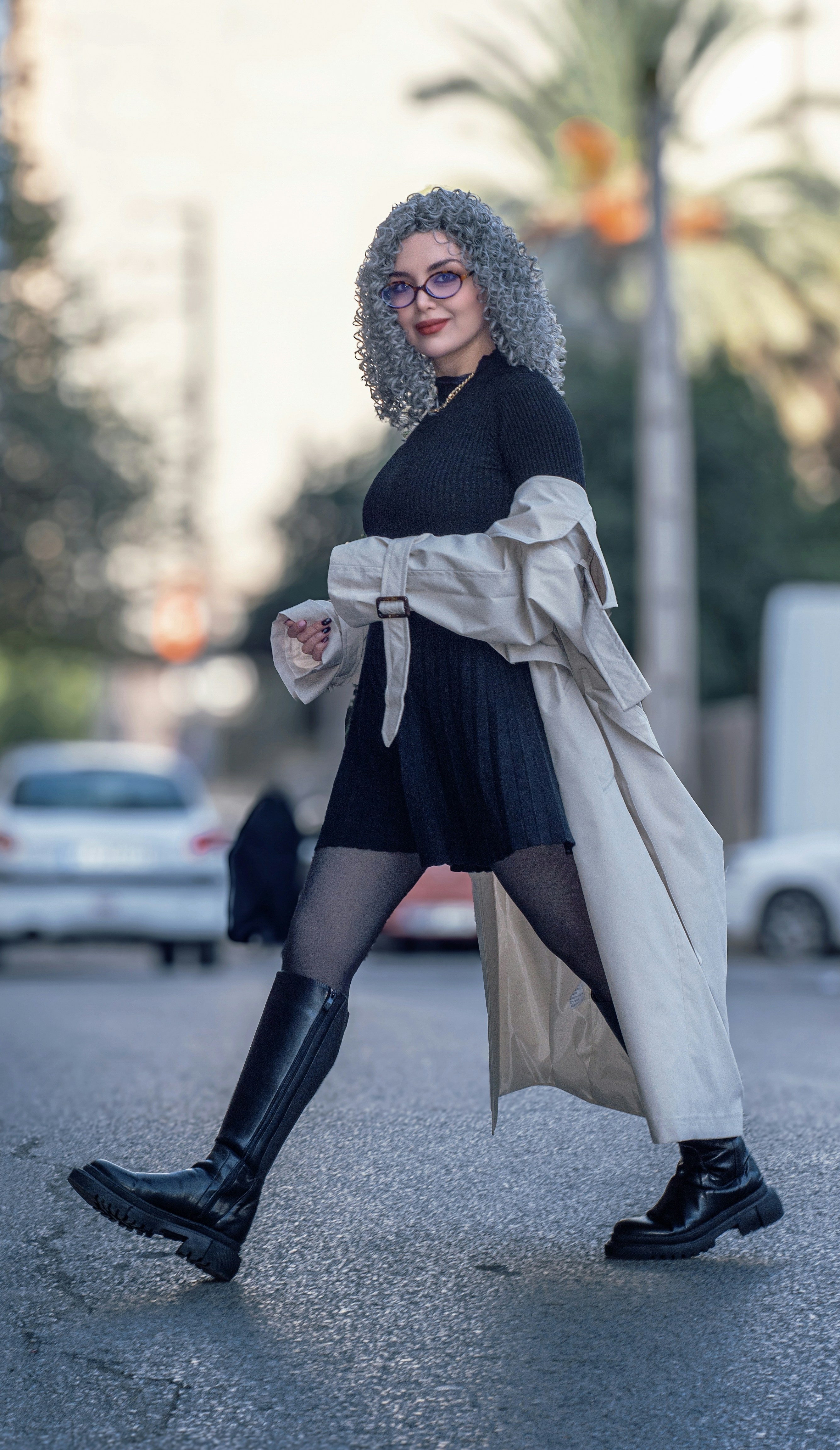 Woman with gray curly hair walking on street