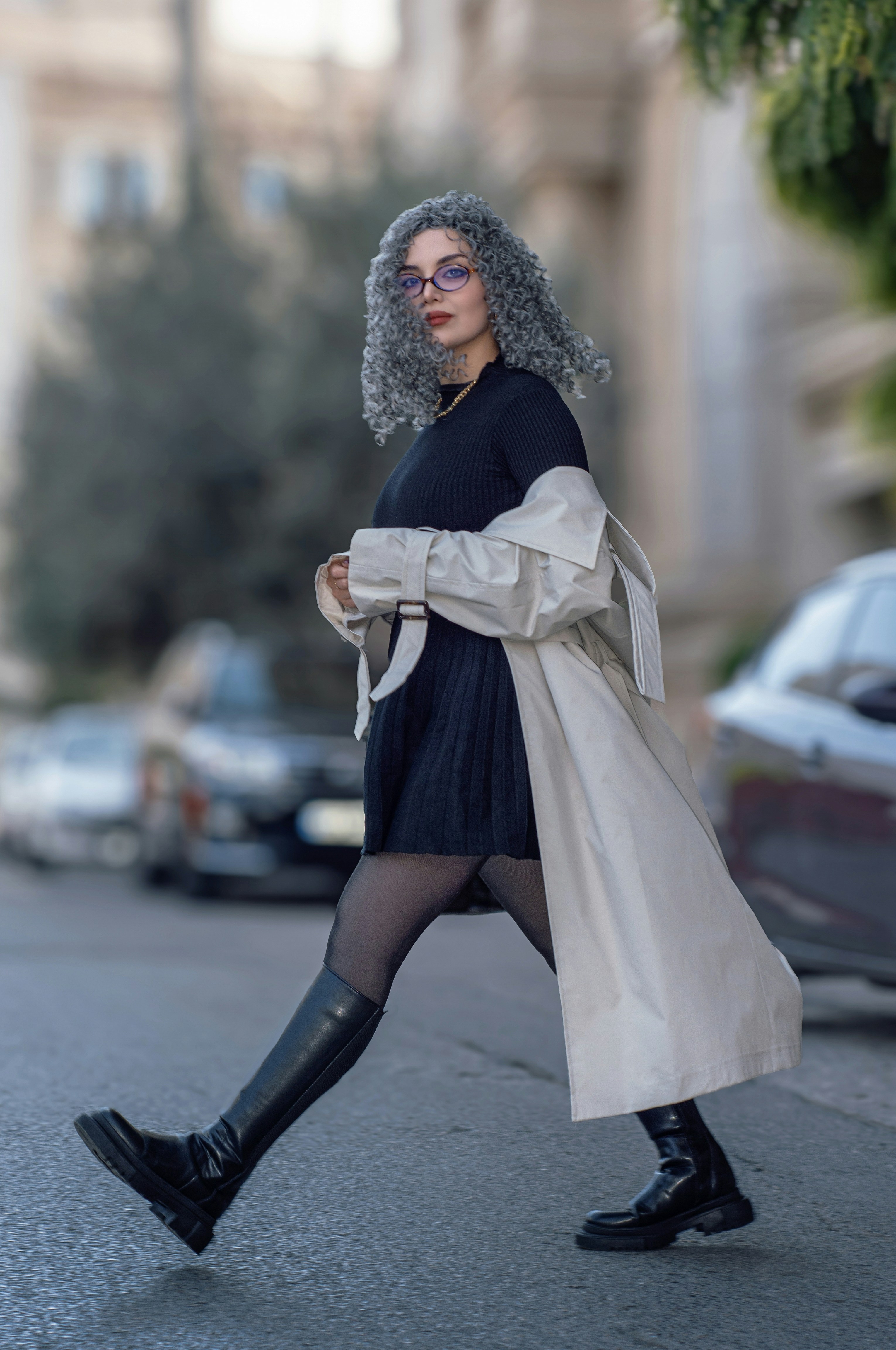 Woman with curly grey hair crossing street