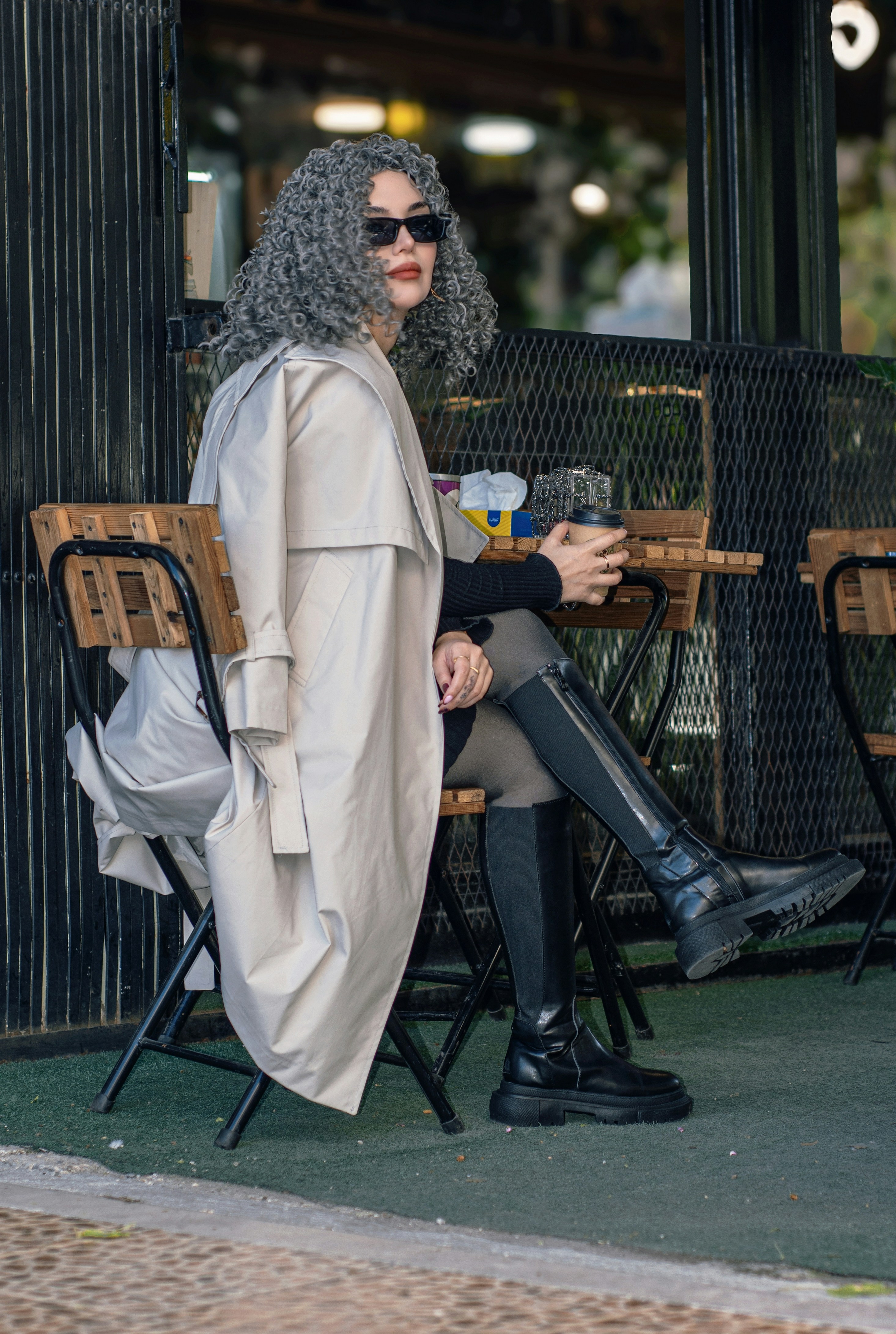 Woman with curly gray hair sitting at a table