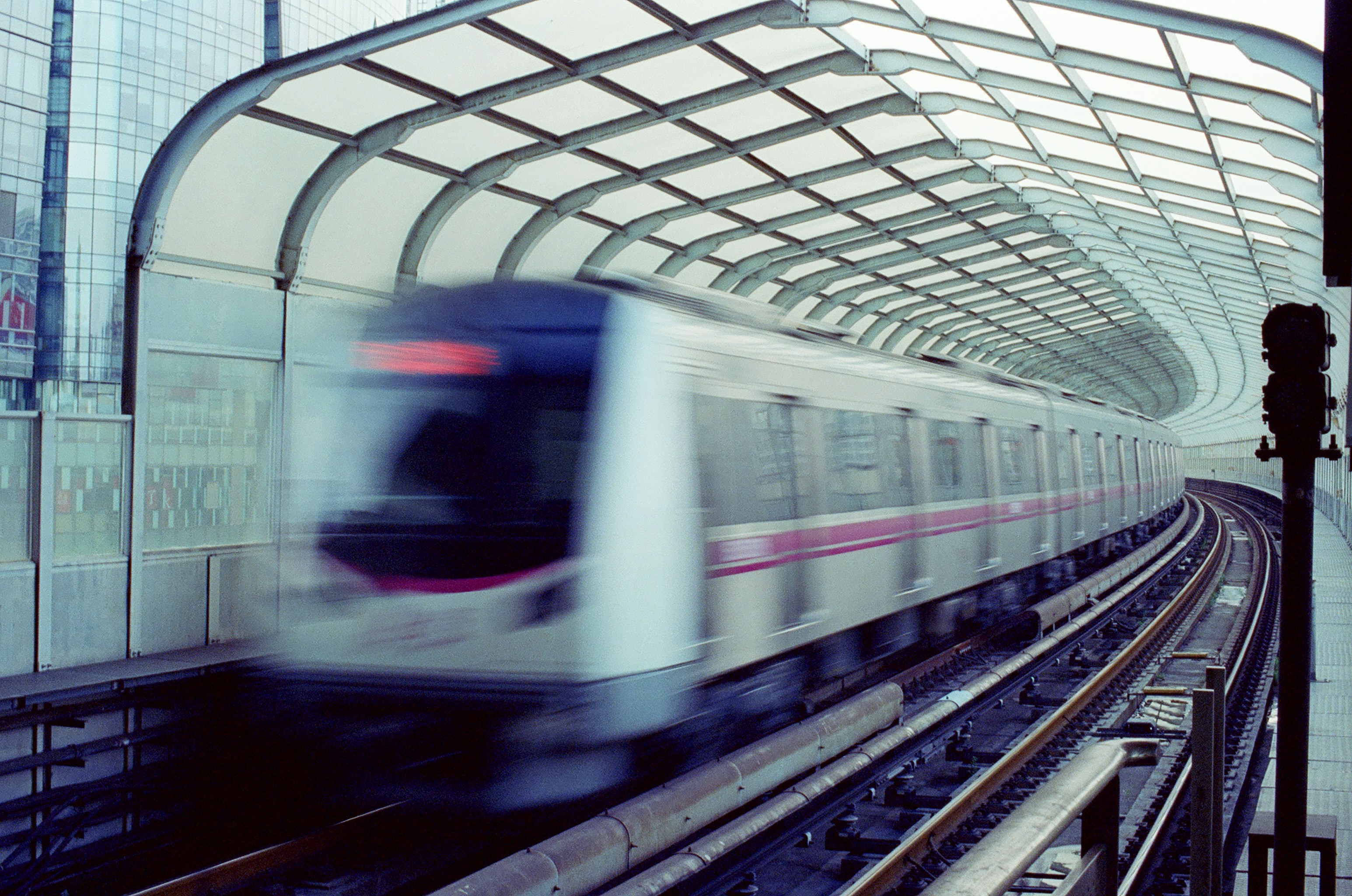 A bustling public meeting or protest scene in Kerala, with people holding placards, some related to infrastructure projects or land acquisition, showing public engagement.
