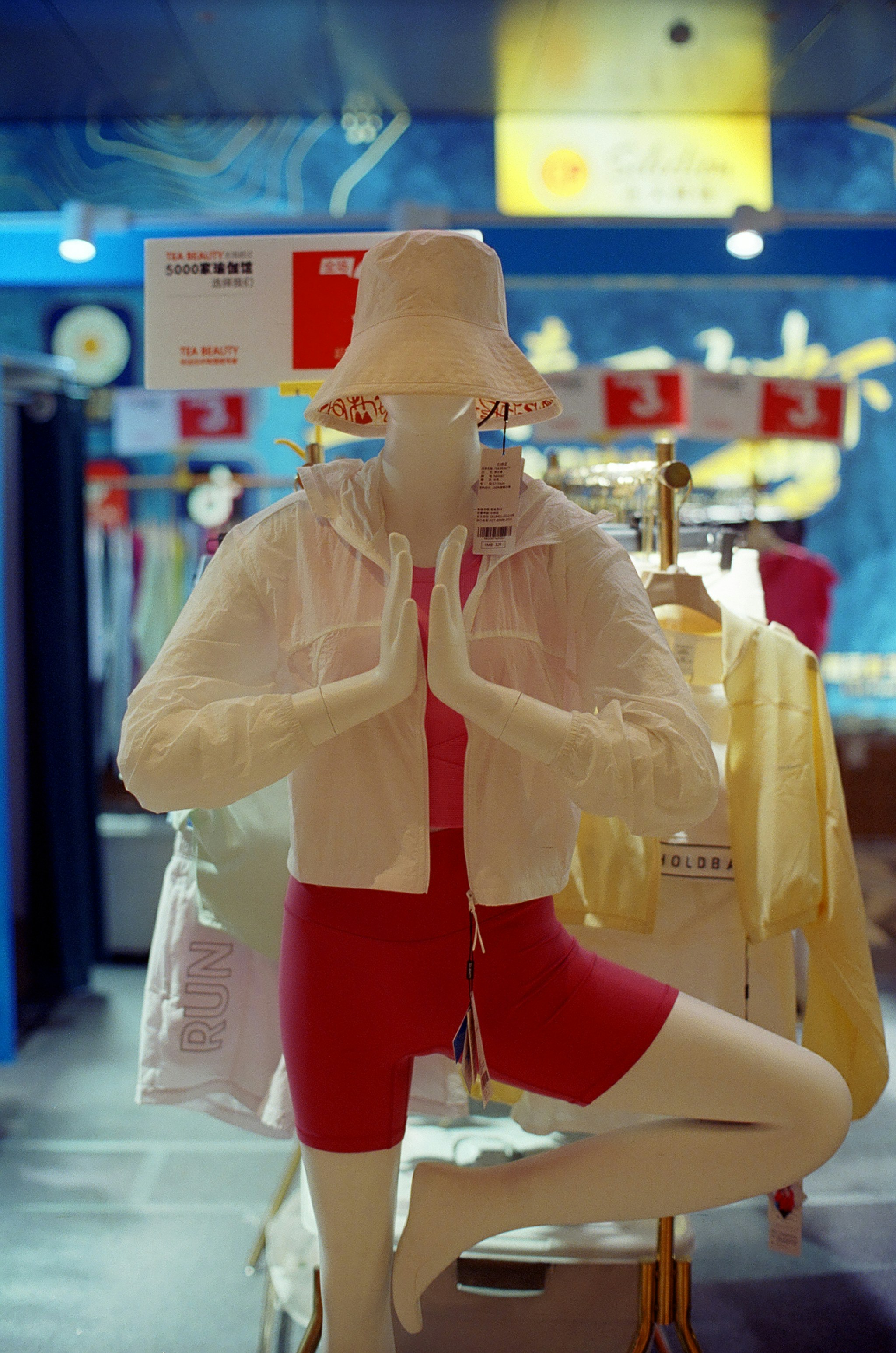 Mannequin in yoga pose wearing athletic wear.