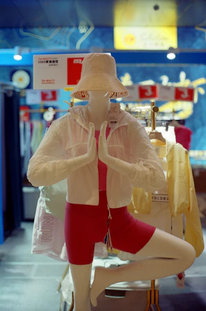 Mannequin in yoga pose wearing athletic wear.