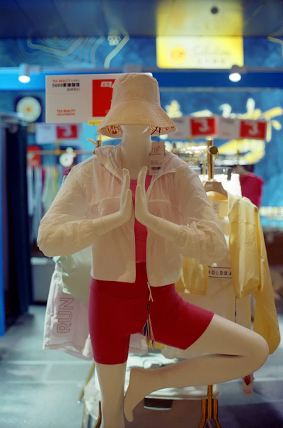 Mannequin in yoga pose wearing athletic wear.