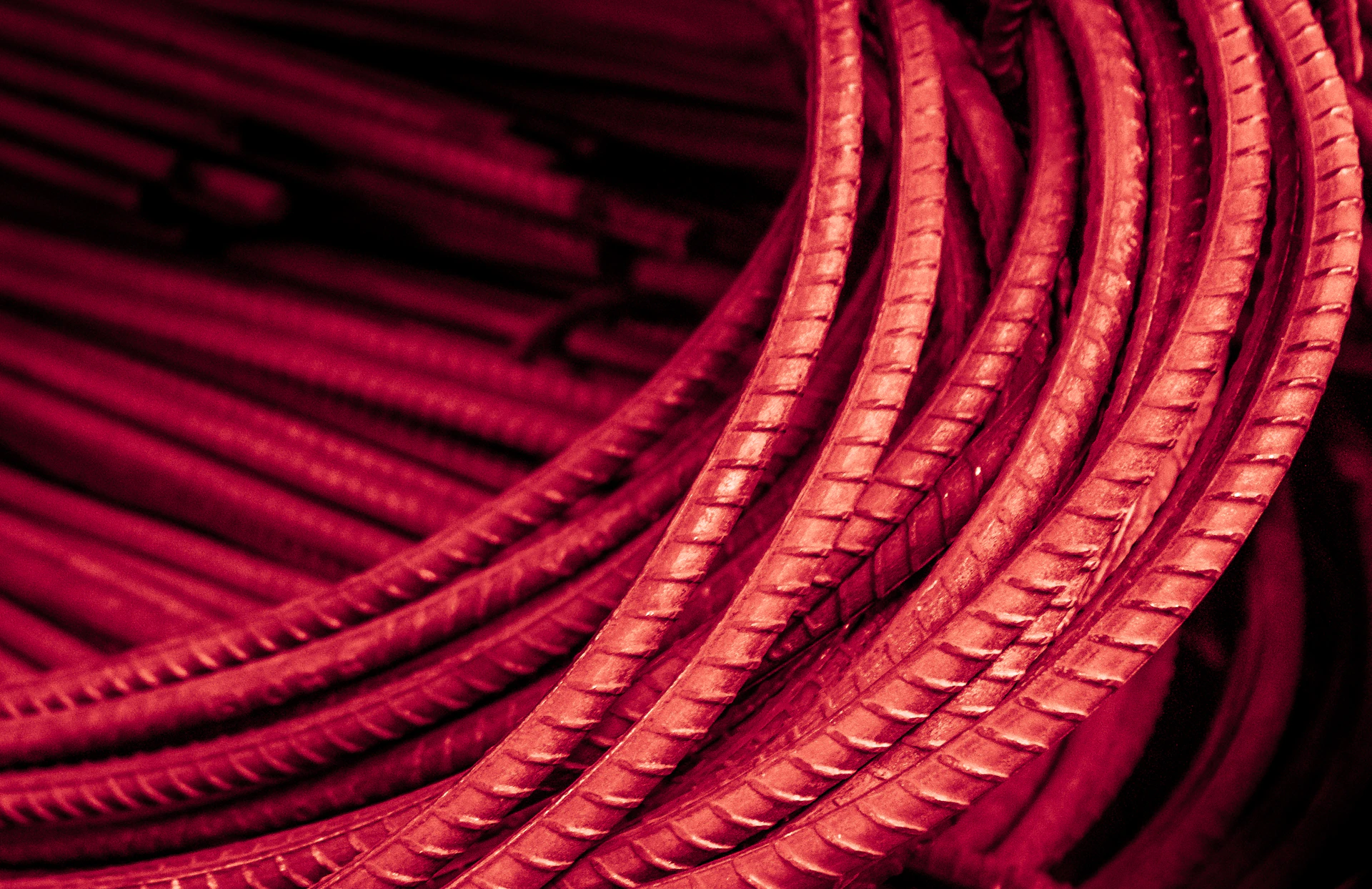 Bundled red metal rods with ribbed texture