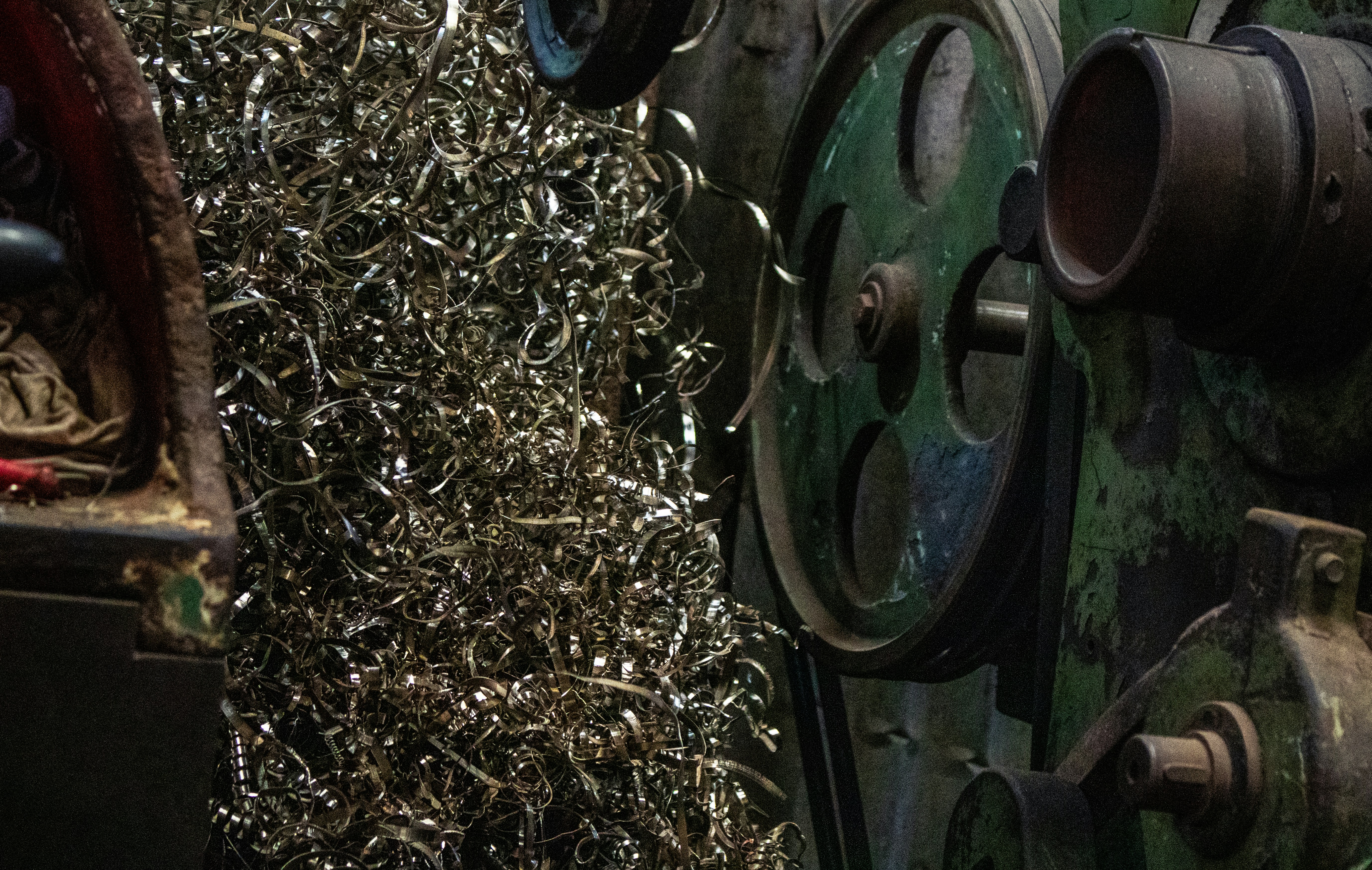 Metal shavings piled next to industrial machinery.