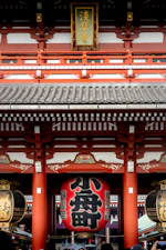 Traditional japanese temple gate with large red lantern.