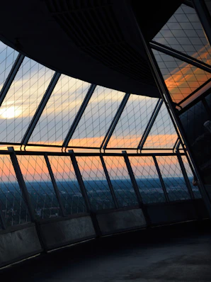 Sunset viewed through a glass observation deck