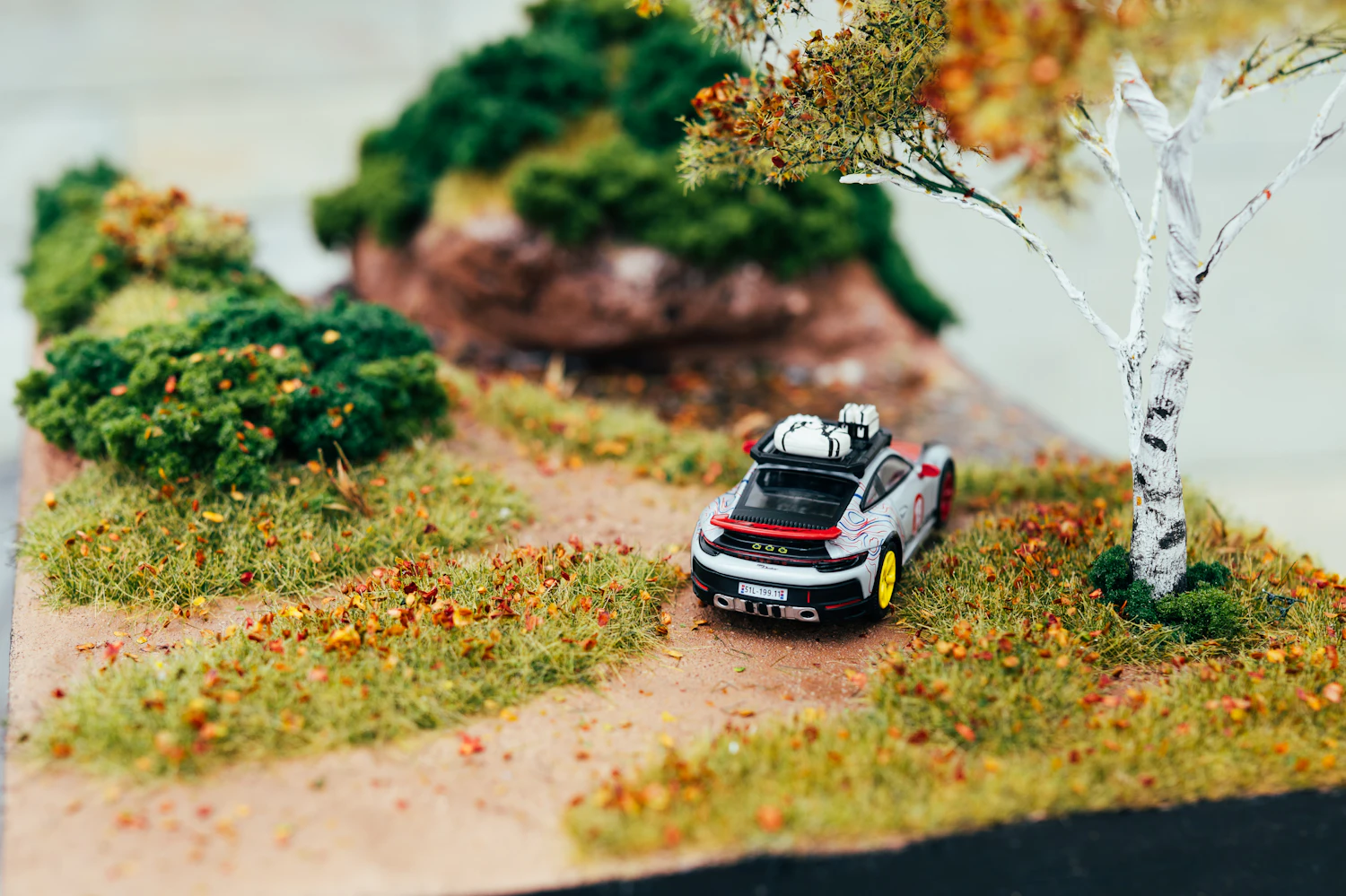A painted model car on a built road surface