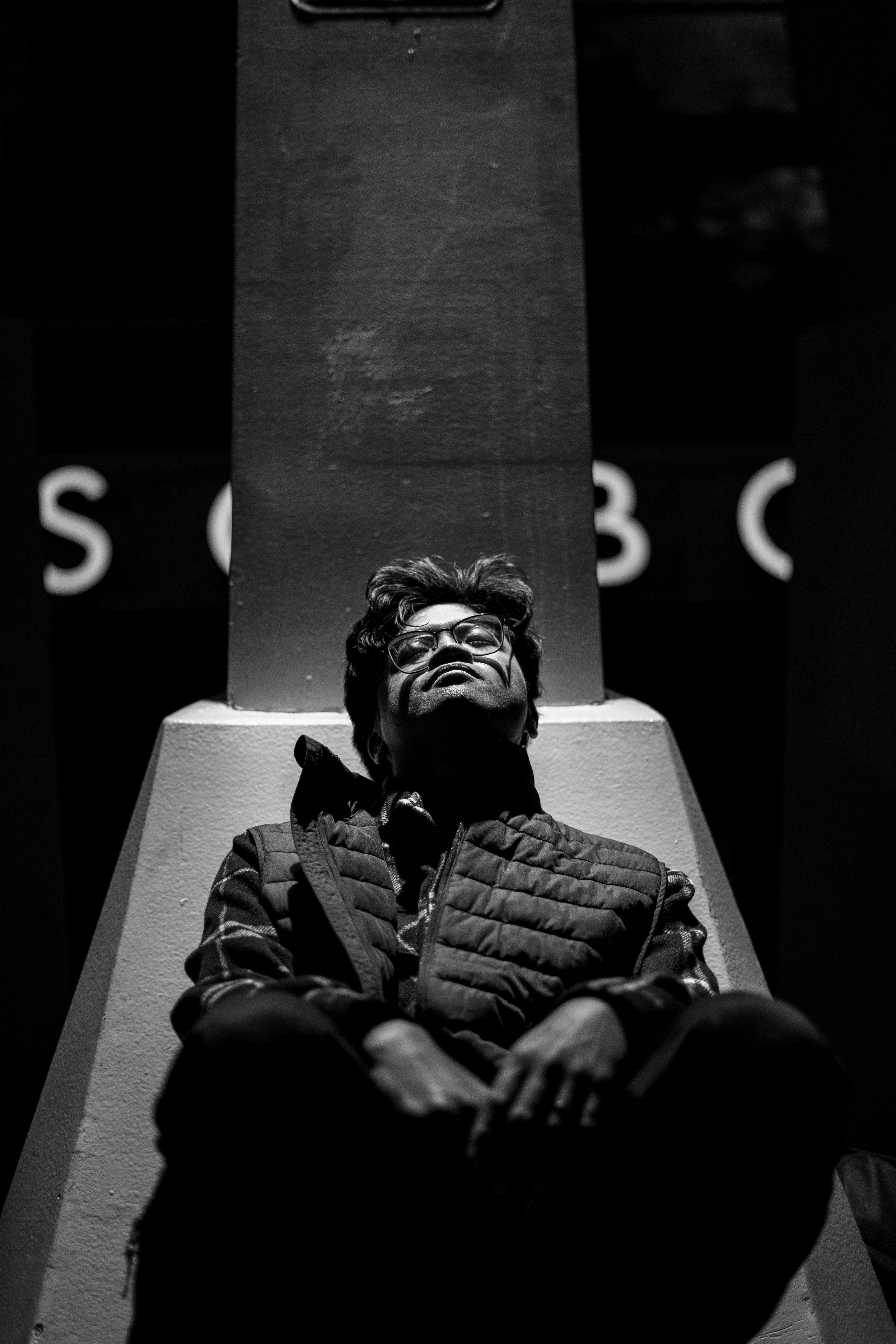 Man sitting with head tilted back looking up