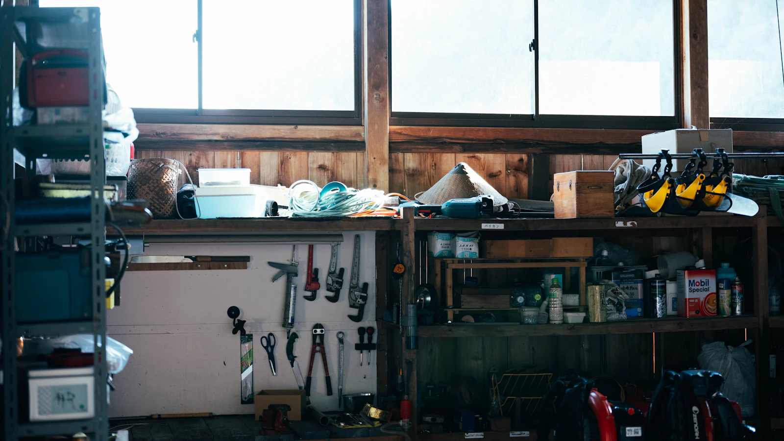 Real workshop workbench with hand tools, maintenance equipment and organized repair supplies