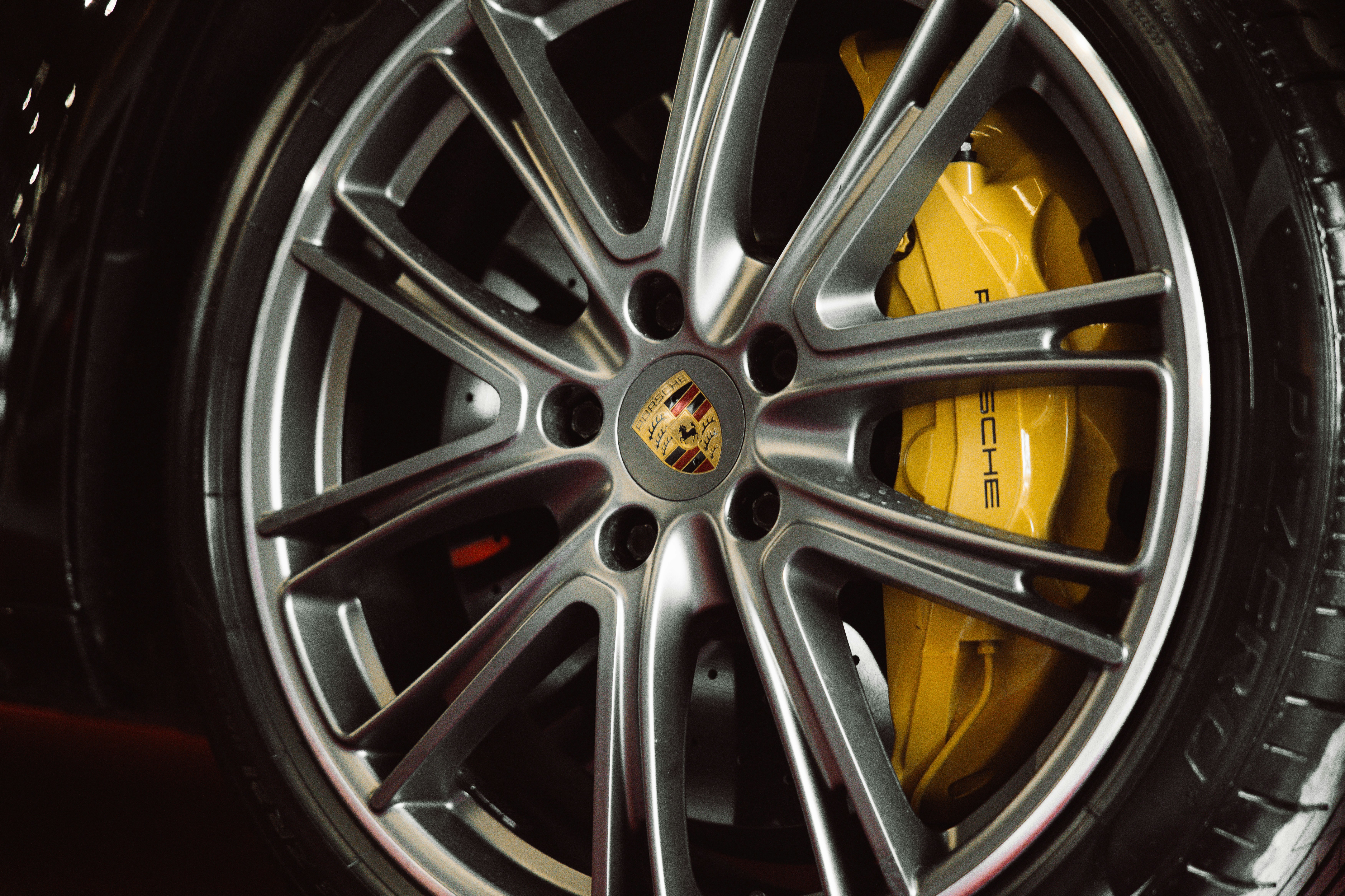 Close-up of a car wheel with yellow brake caliper
