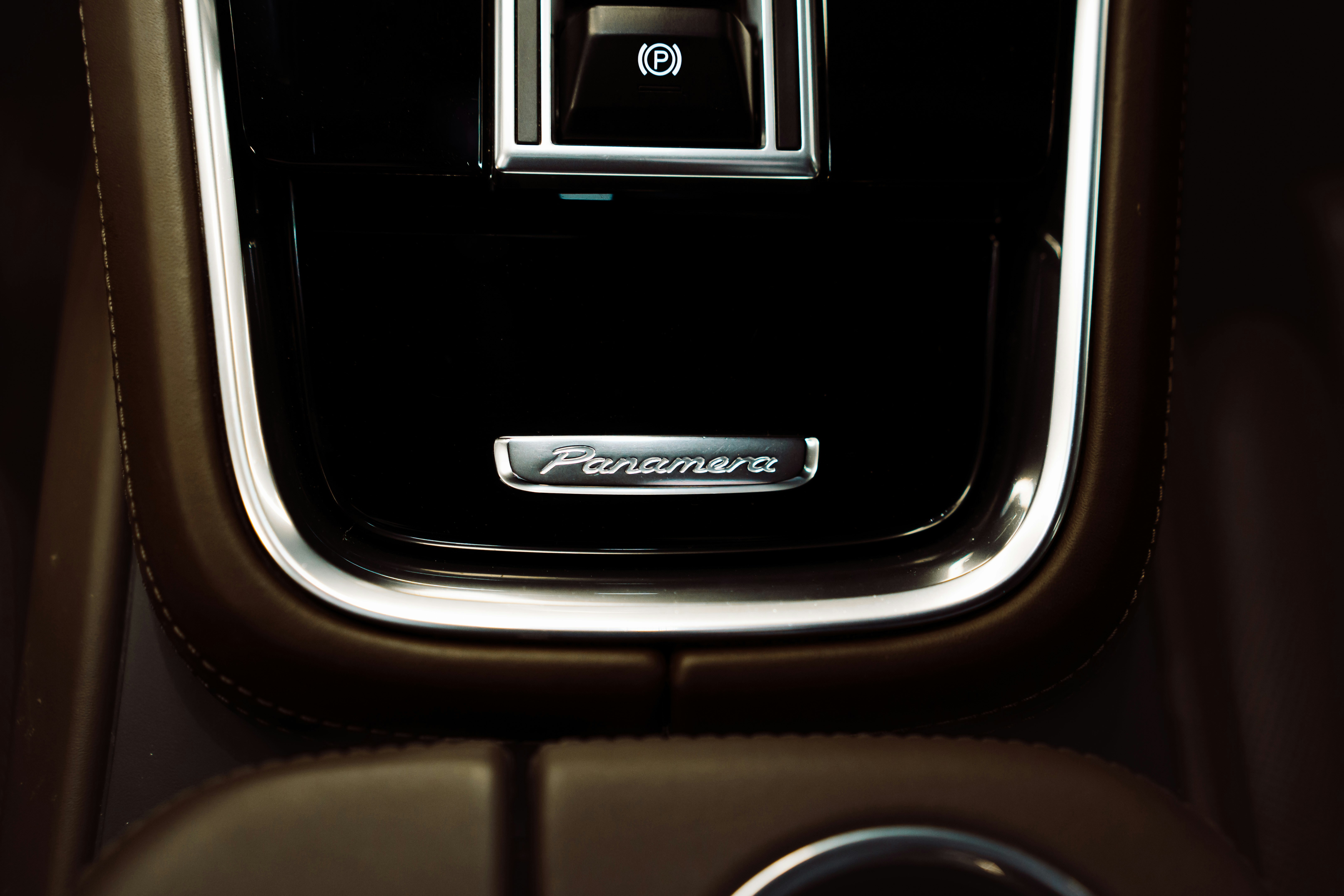 Close-up of the panamera emblem on a car's interior.
