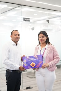 Man and woman holding cadbury celebrations box