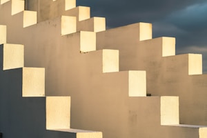 Geometric white staircase with dramatic sky