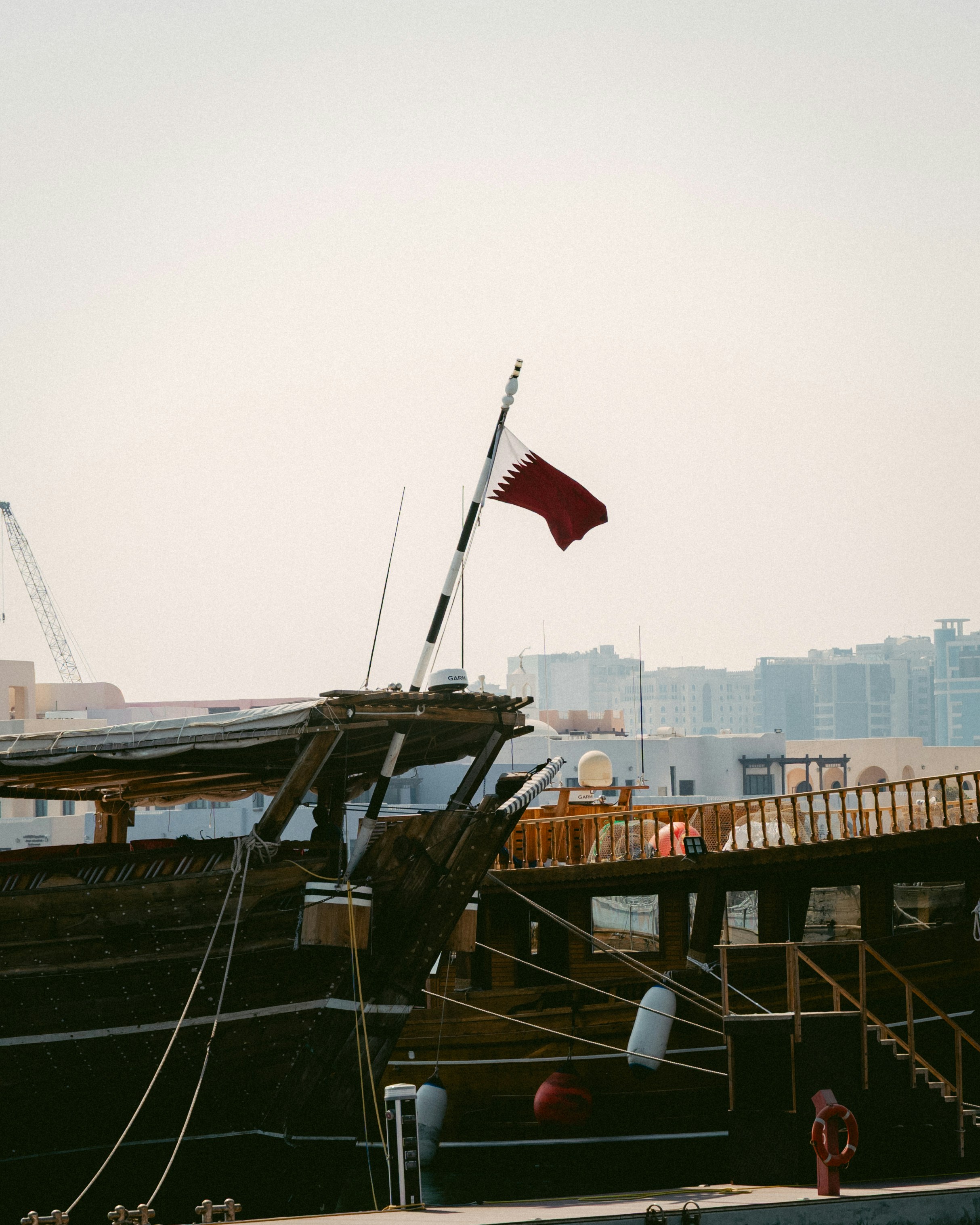 Dhow boats with qatar flag at harbor