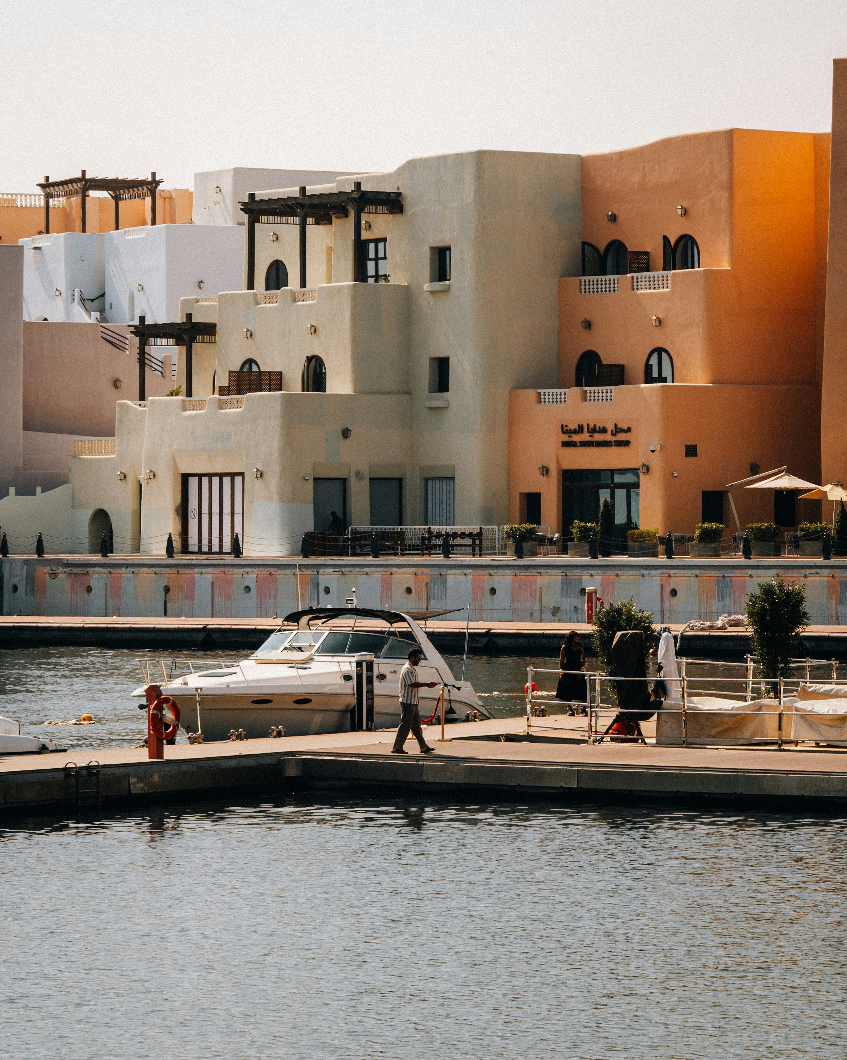 Buildings on the waterfront with boats docked nearby.