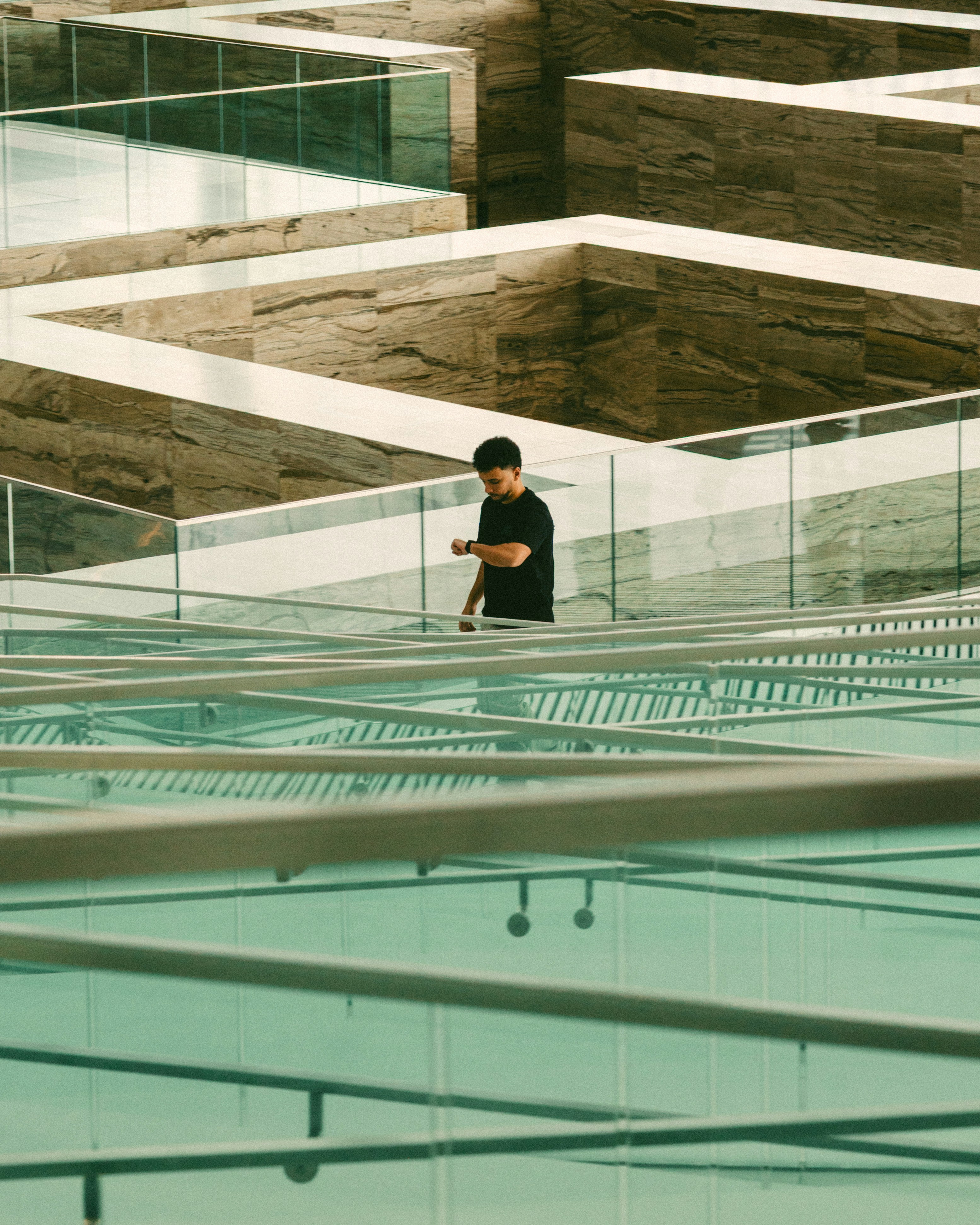 Man walking through a modern architectural maze.