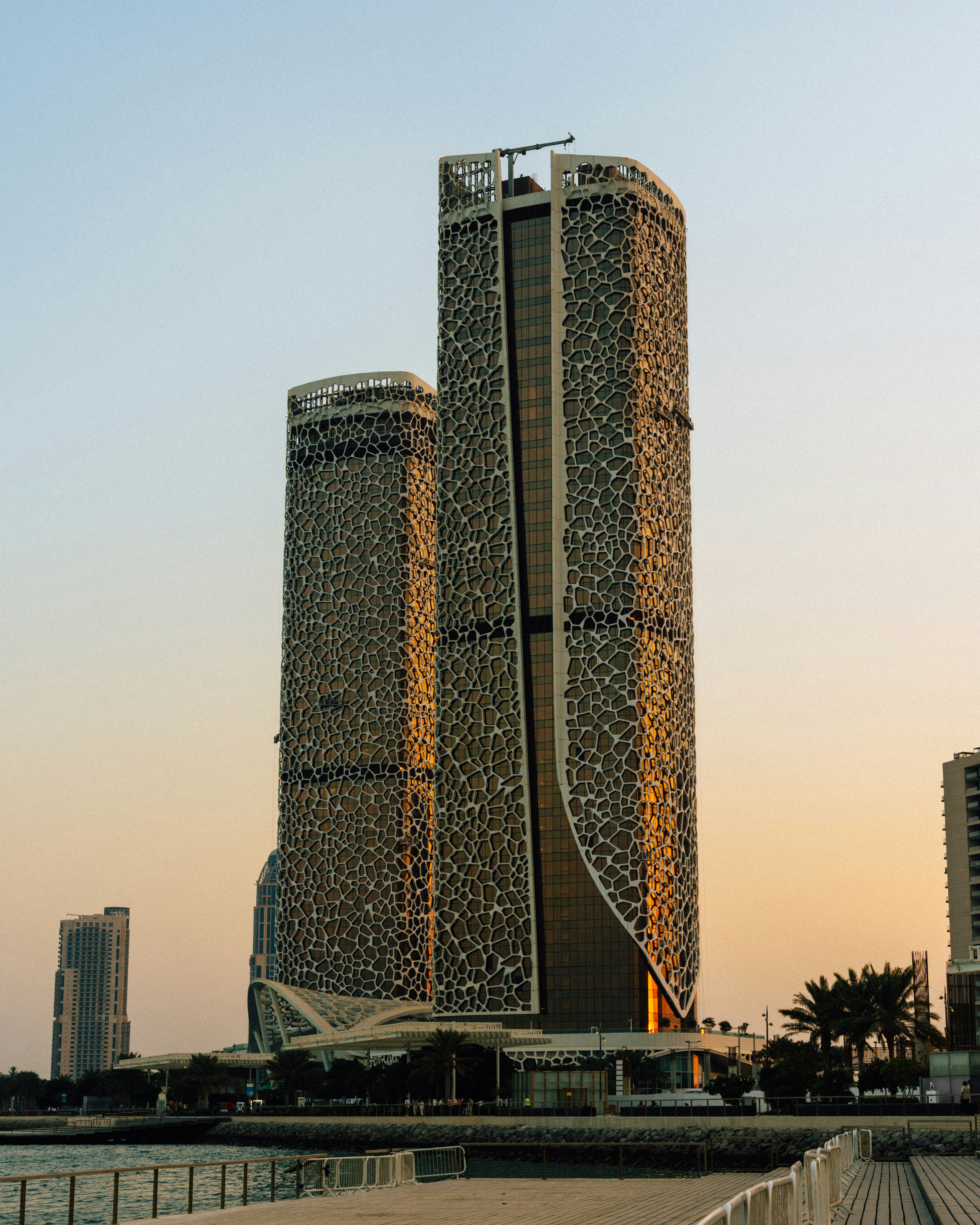 Modern skyscrapers illuminated by warm sunset light.