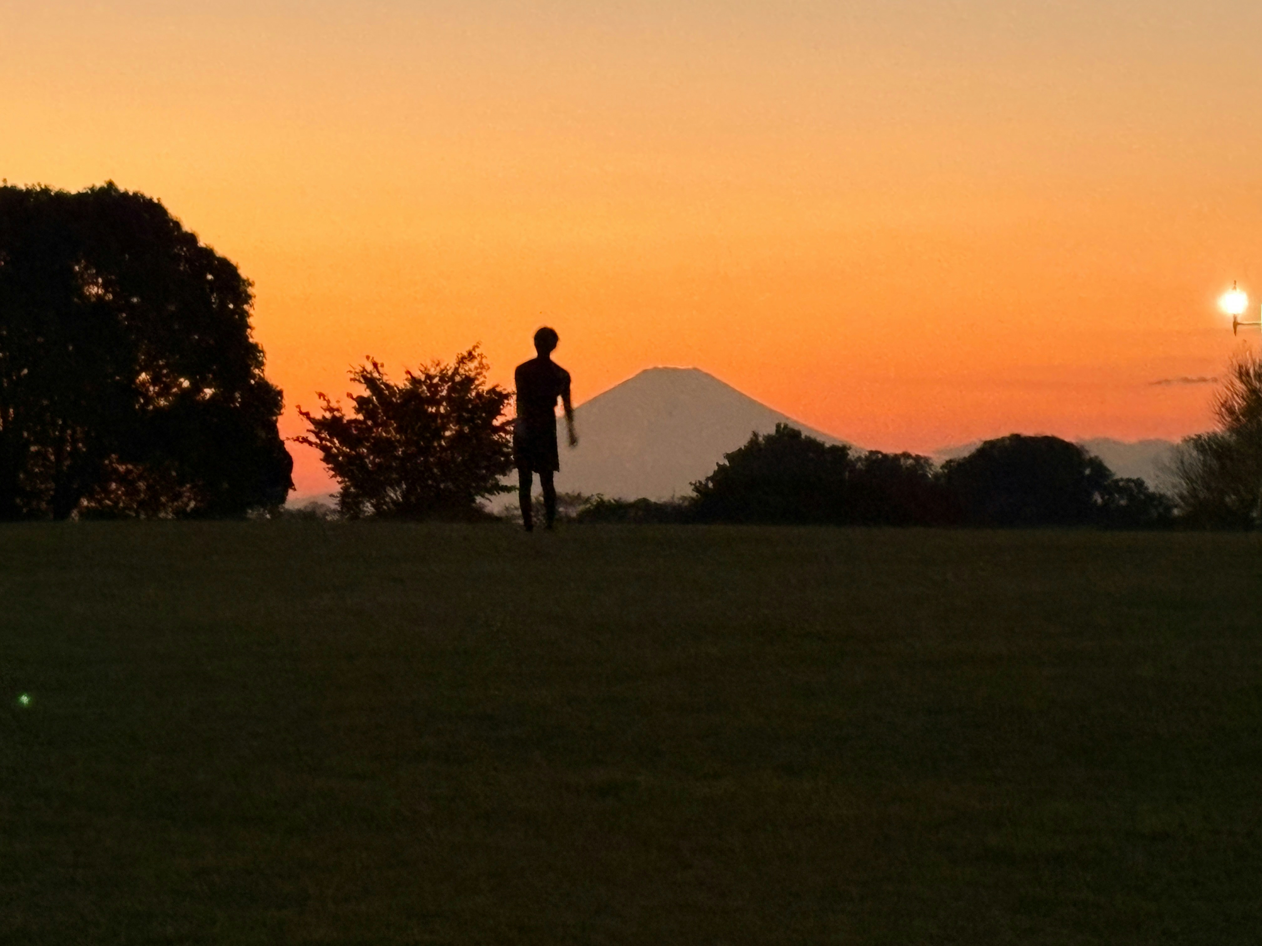 People watching the sunrise over a tranquil Japanese landscape for Hatsuhinode