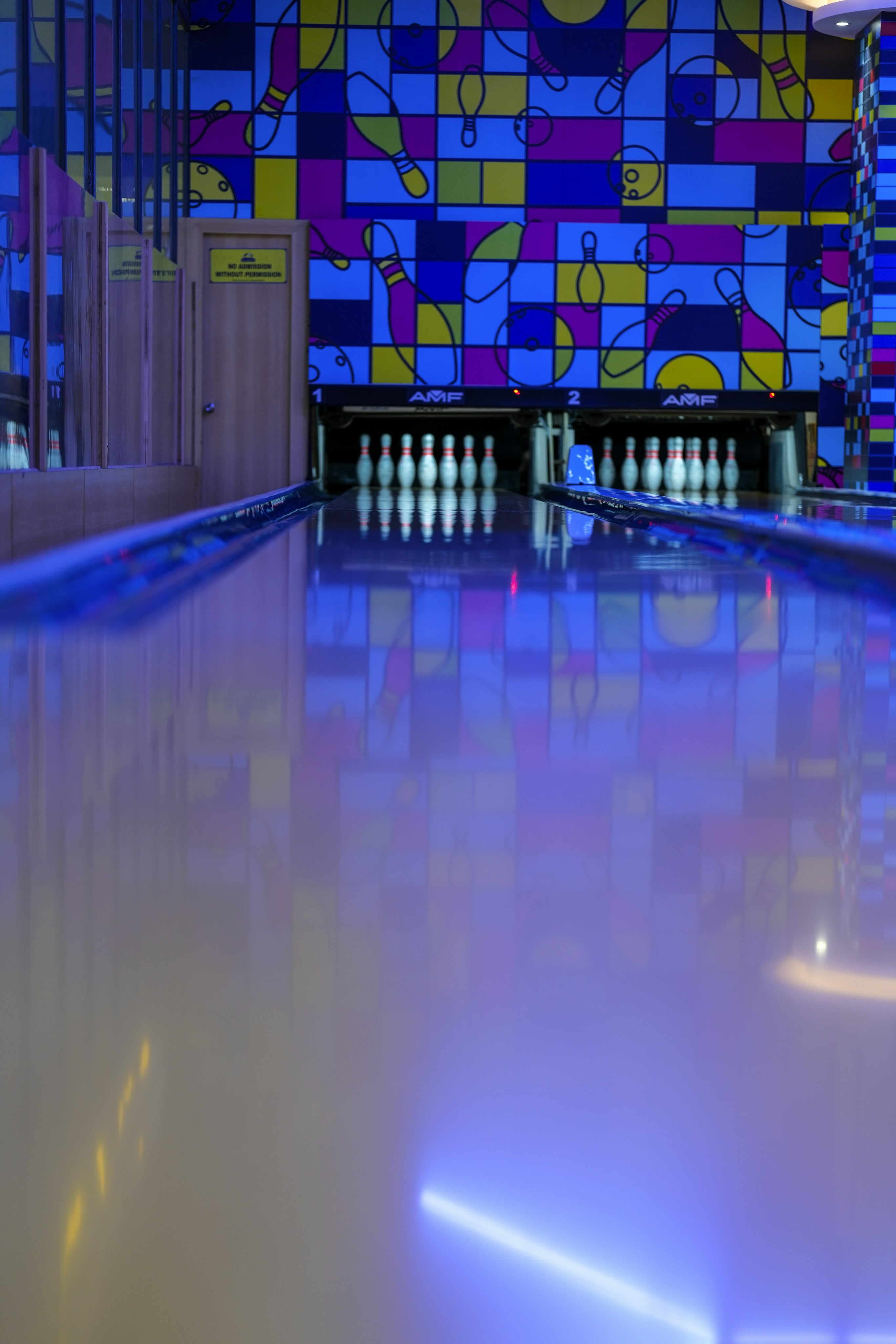 Bowling alley with colorful walls and pins