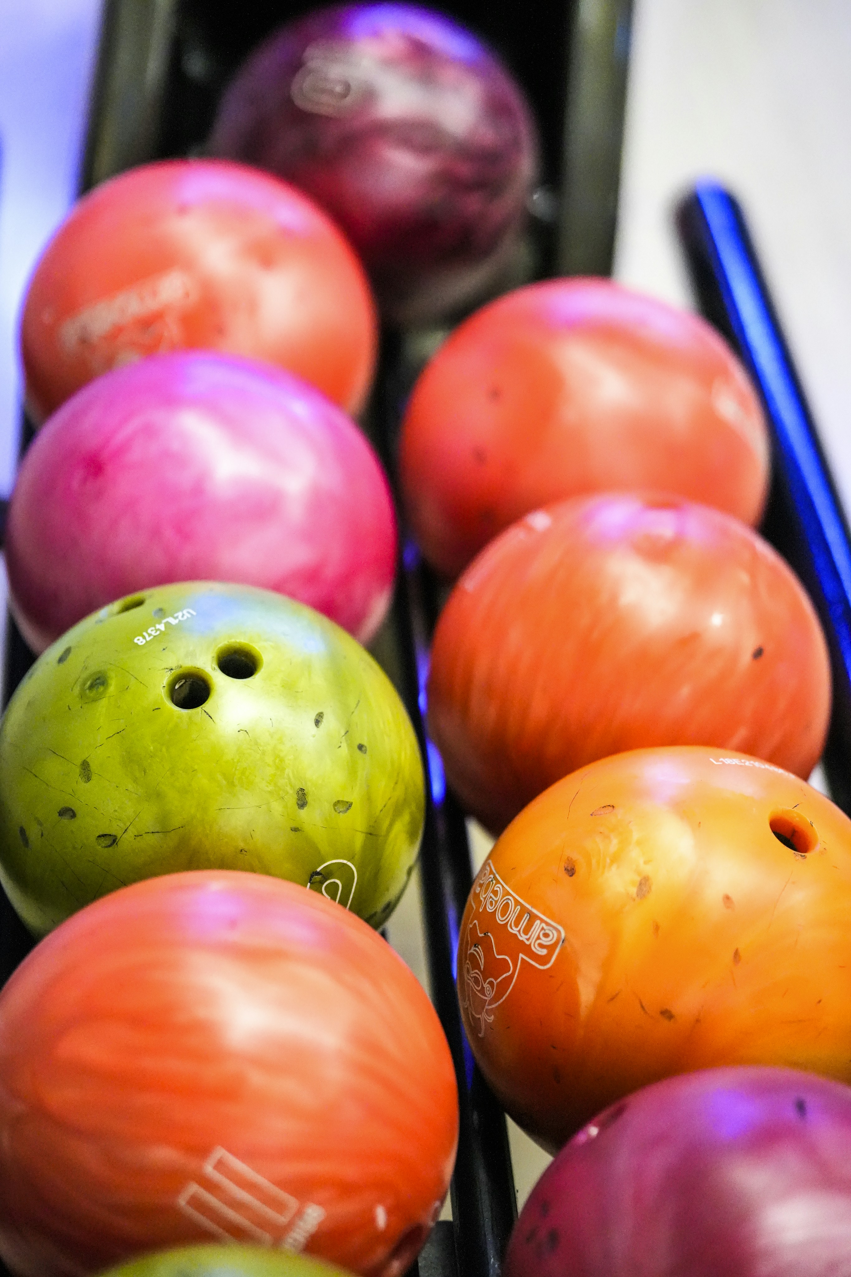 A rack of colorful bowling balls