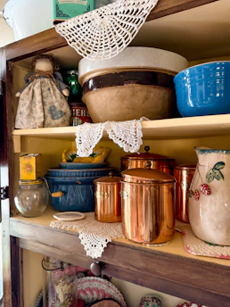 Vintage kitchen cabinet with cookware and decor