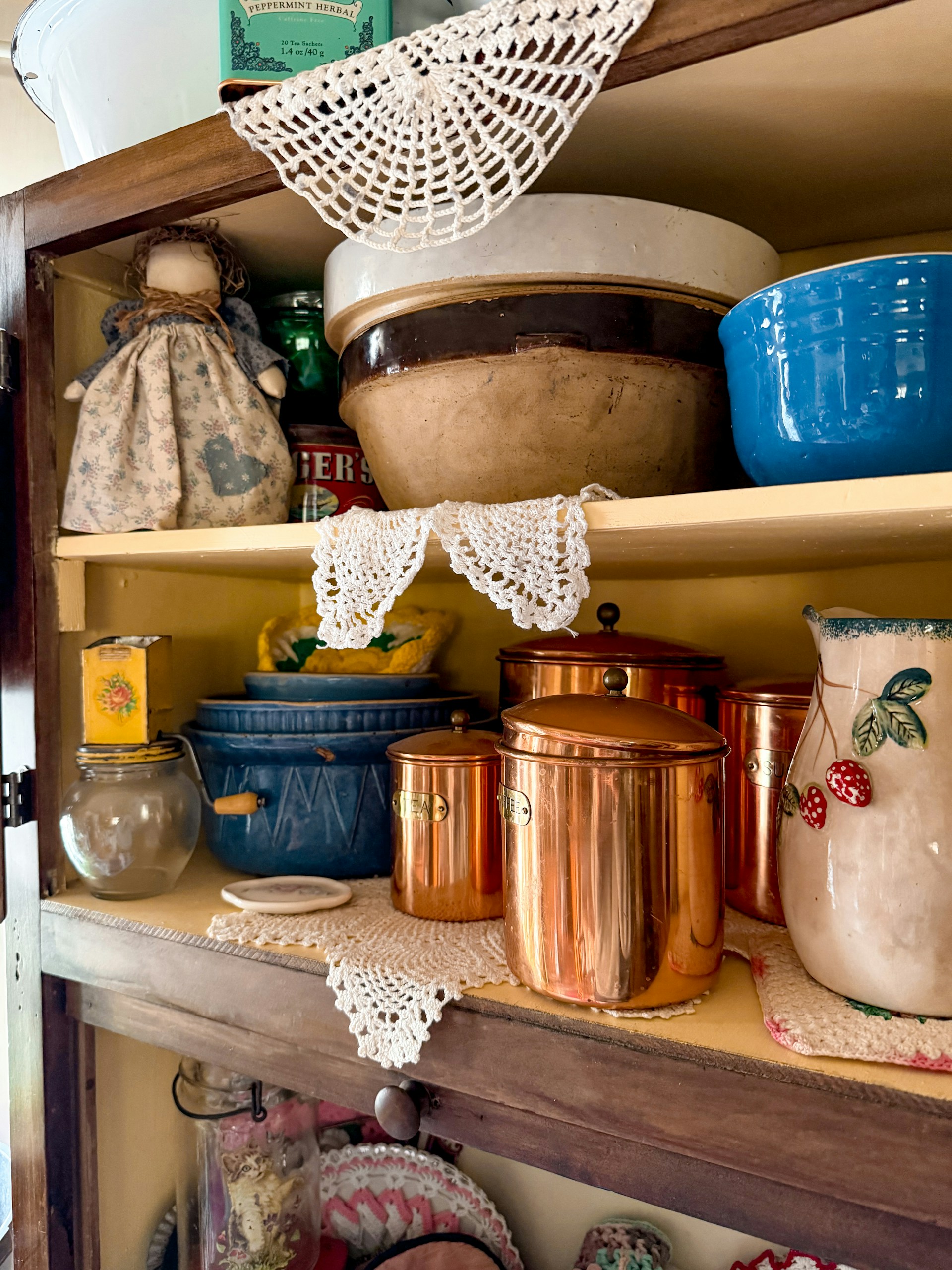 Vintage kitchen cabinet with cookware and decor