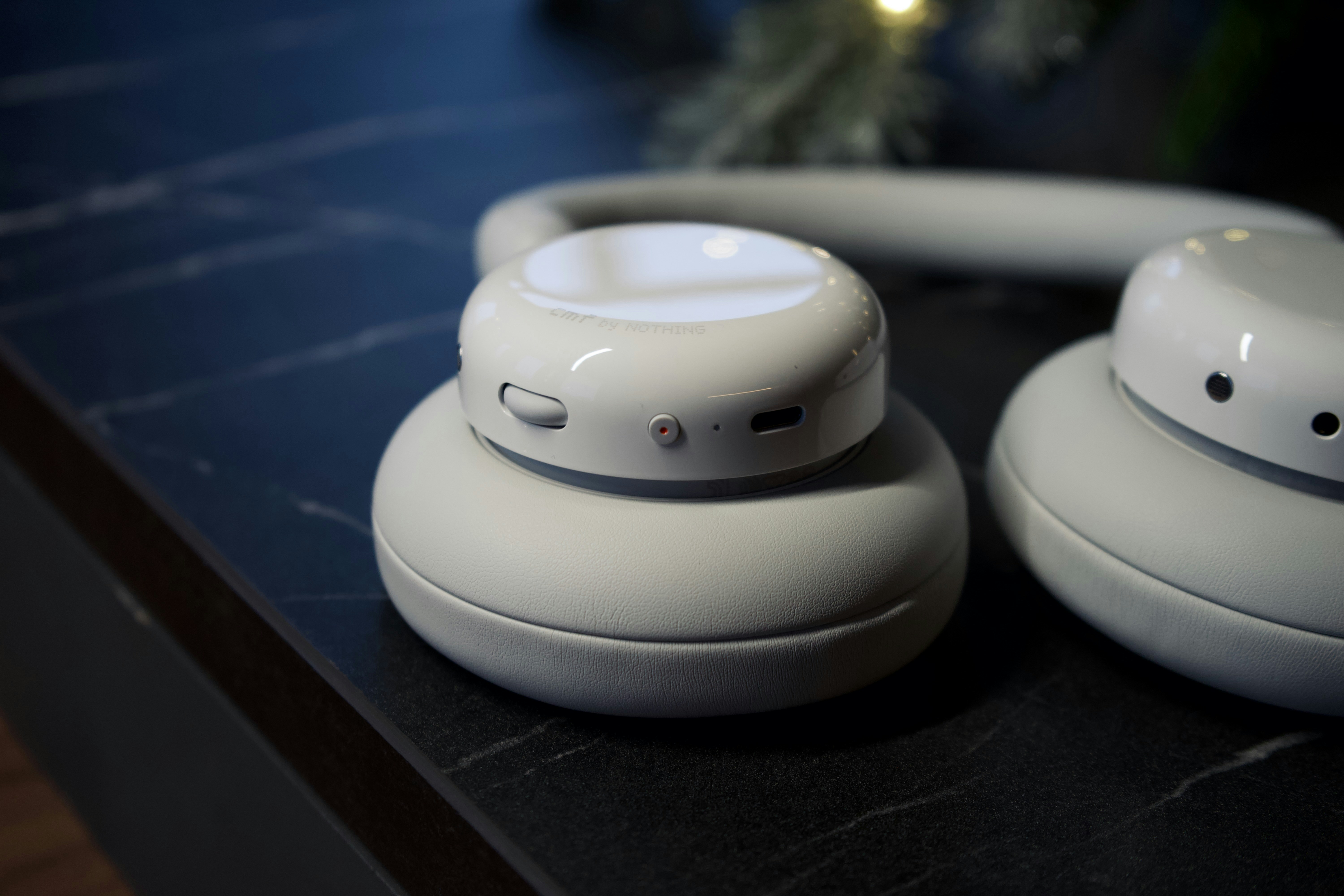 Close-up of beige wireless headphones on a dark surface