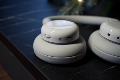 Close-up of beige wireless headphones on a dark surface