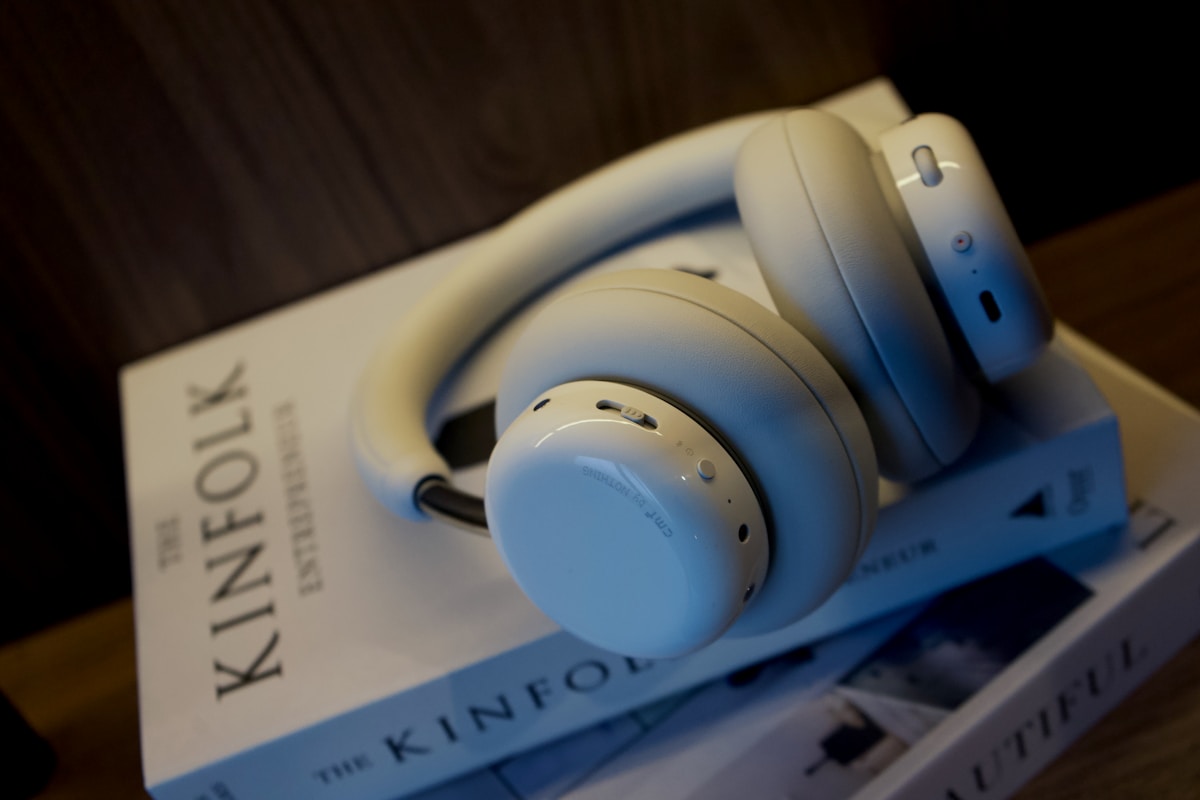 White headphones resting on books