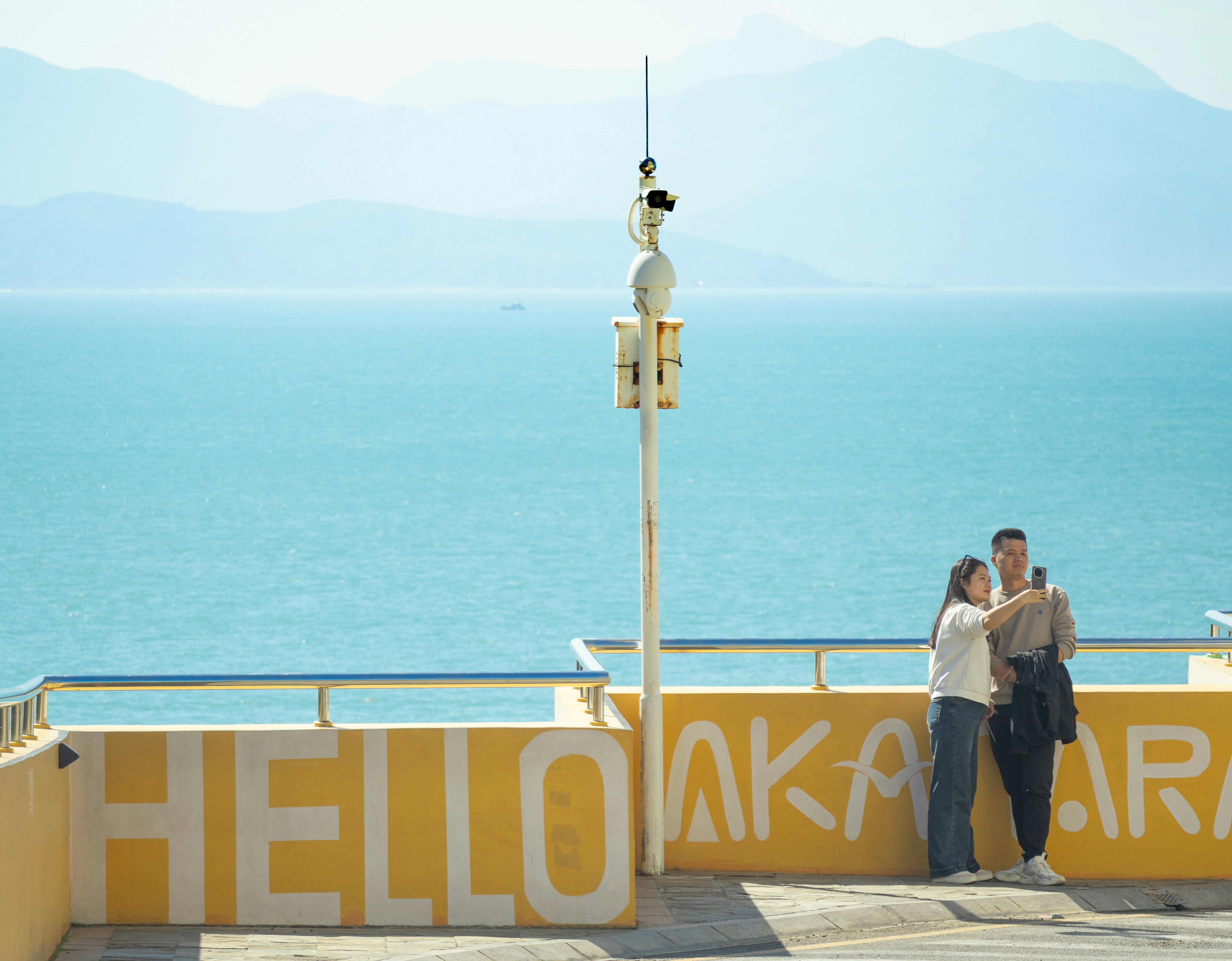 Couple taking a selfie by the ocean