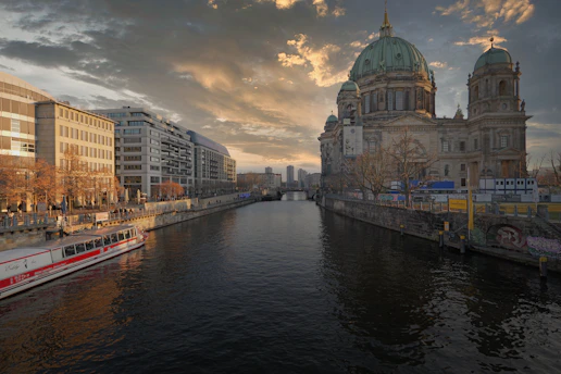 River with buildings and cathedral at sunset