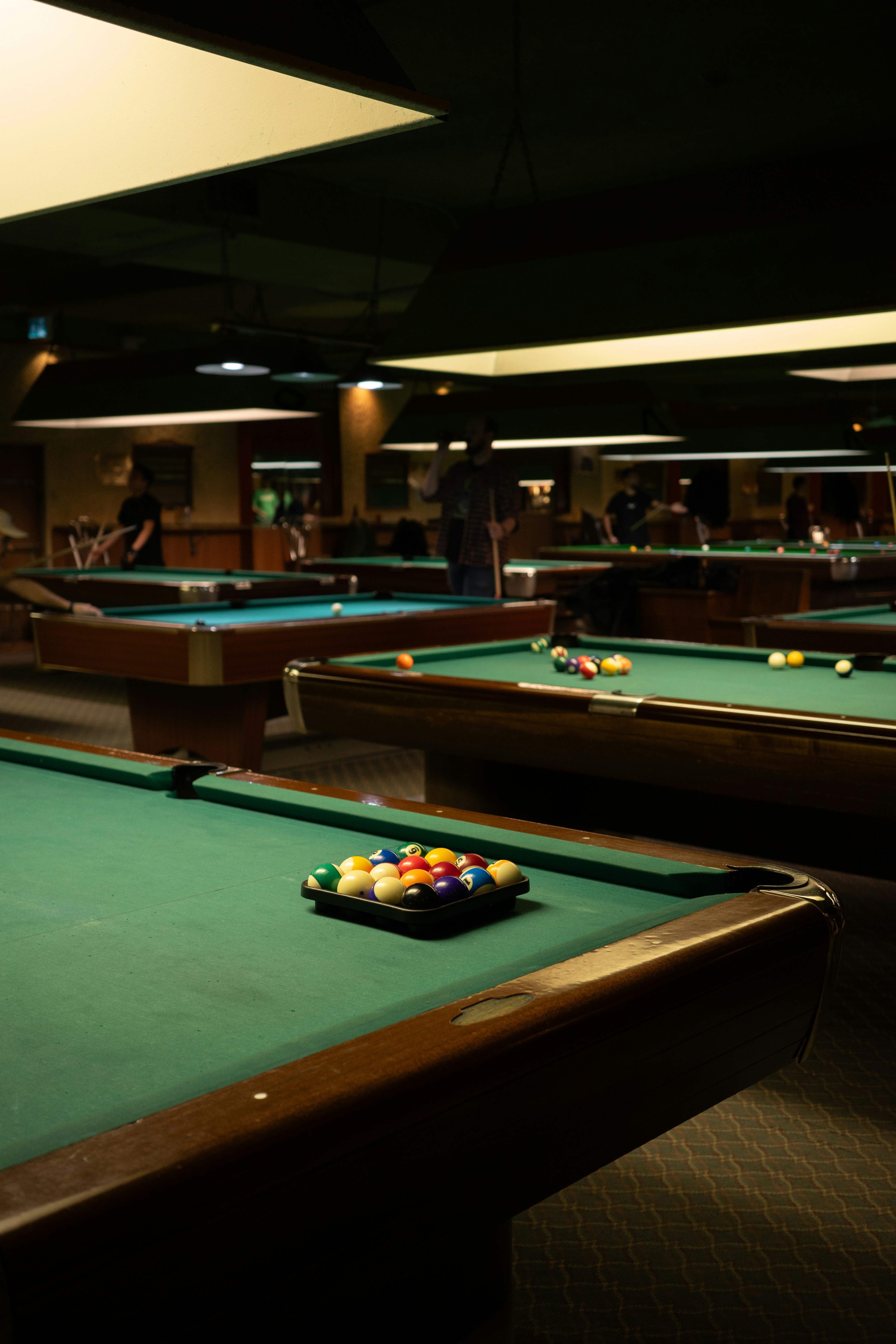 Pool balls racked on a green felt billiard table.