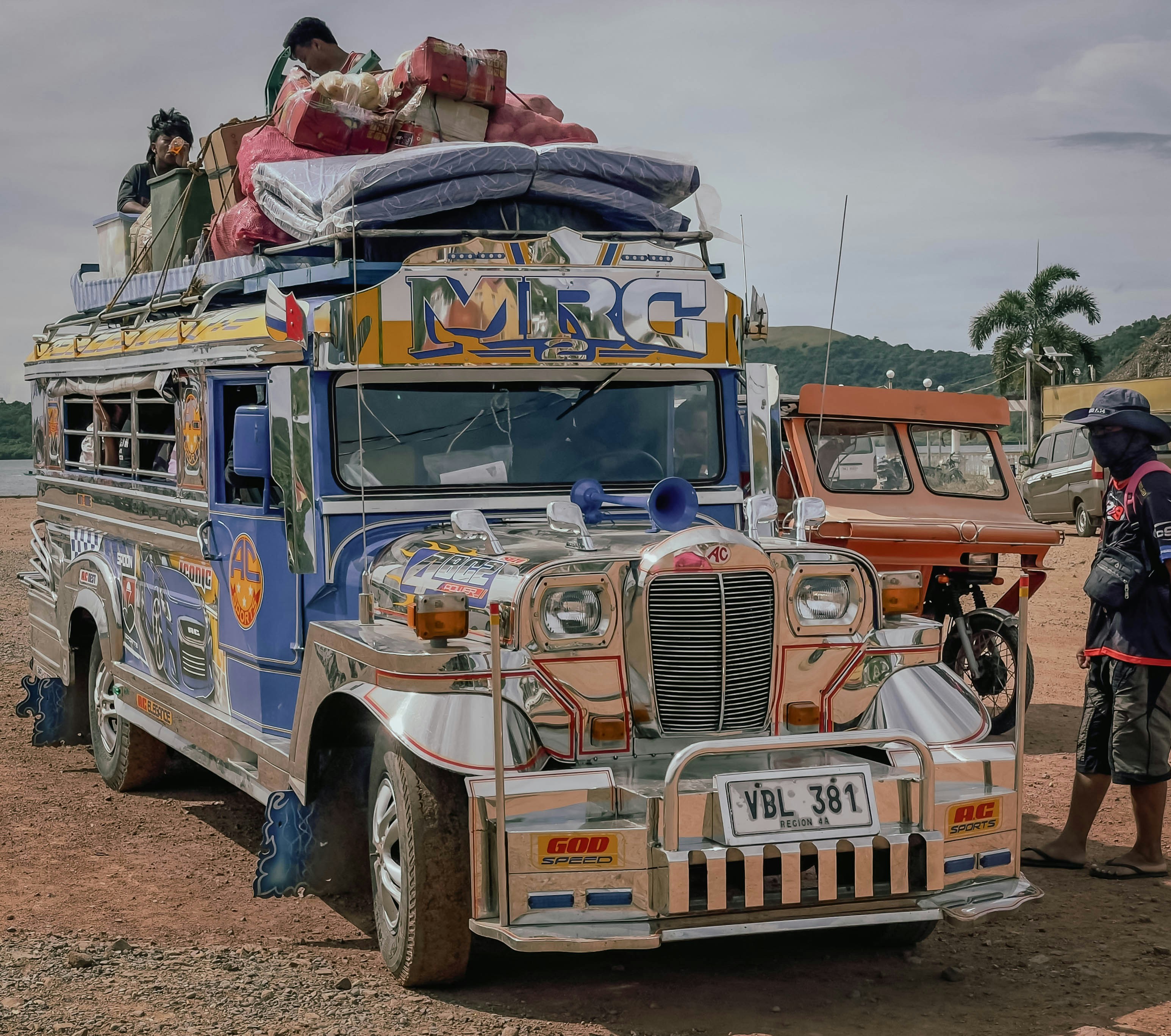 Colorful jeepney overloaded with luggage and passengers