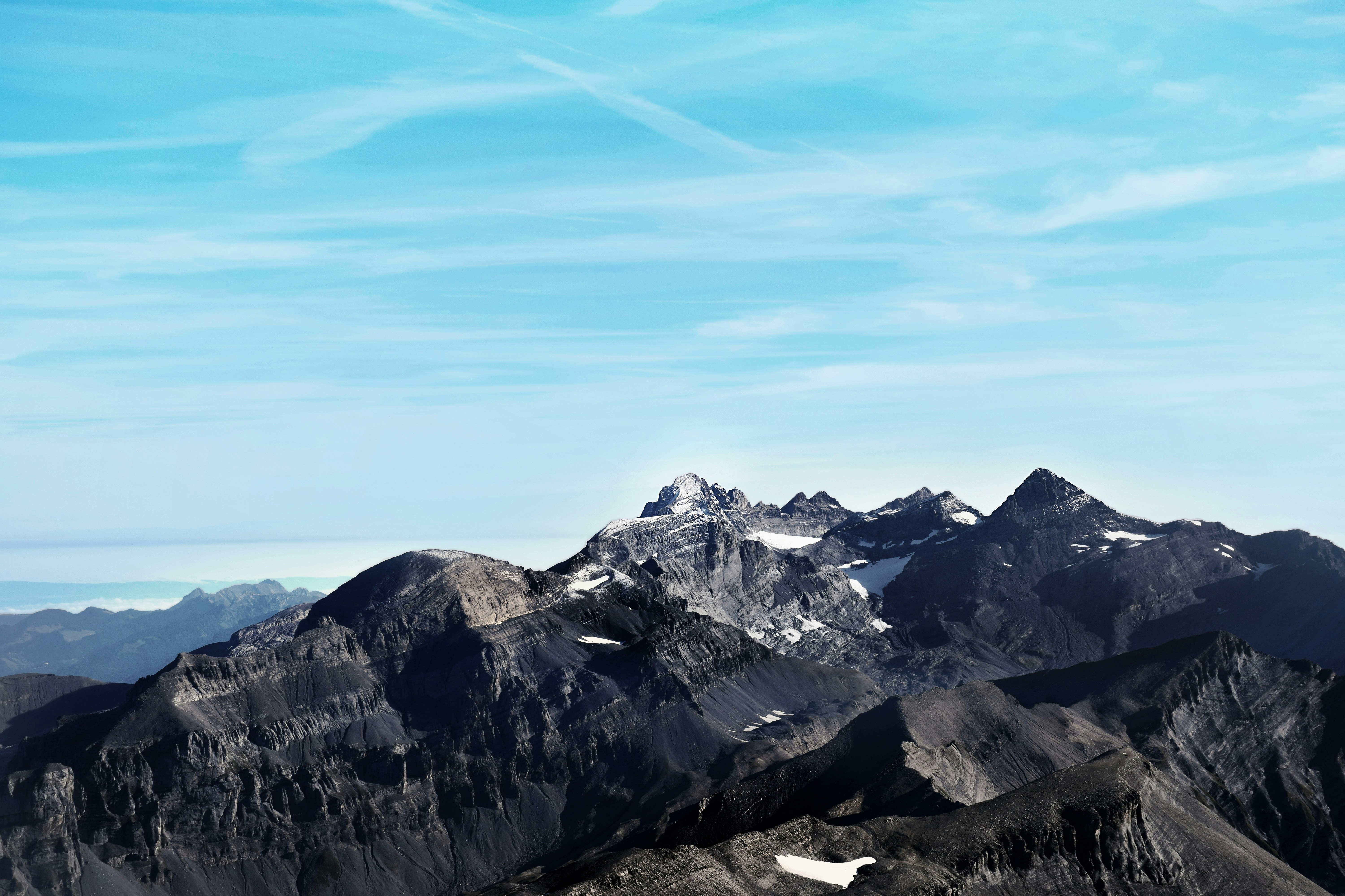 Jagged mountain peaks under a bright blue sky