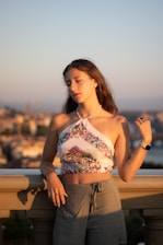 A young woman in a halter top outdoors at sunset