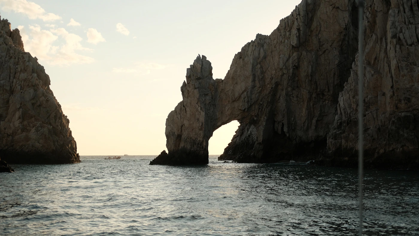 Rock arch formation in the ocean at sunset in Los Cabos Baja California Mexico showing the famous El Arco natural granite arch at Land s End
