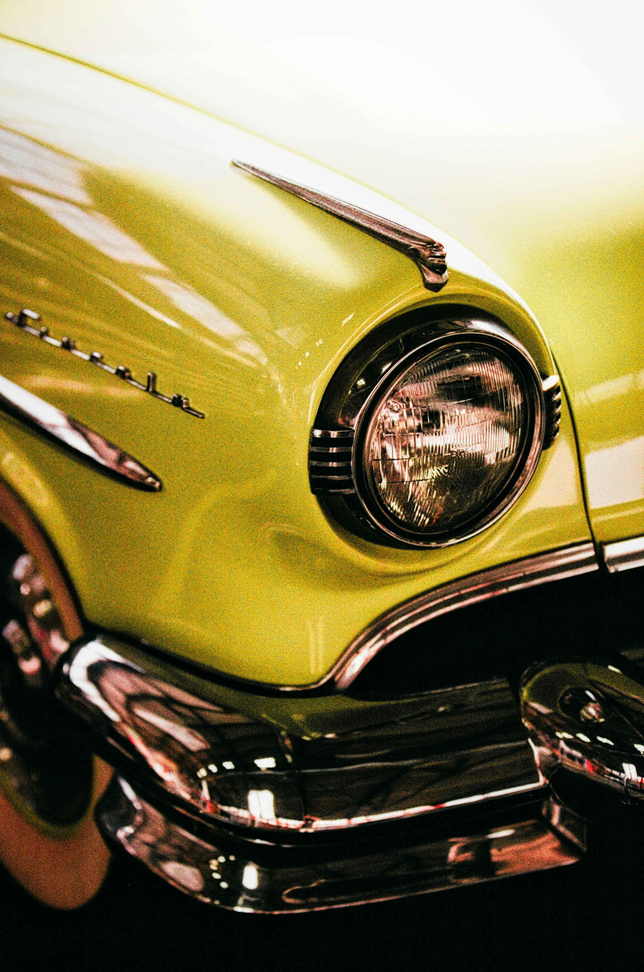 Close-up of a vintage yellow car headlight