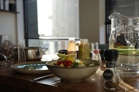 A fresh salad in a bowl on a wooden table.