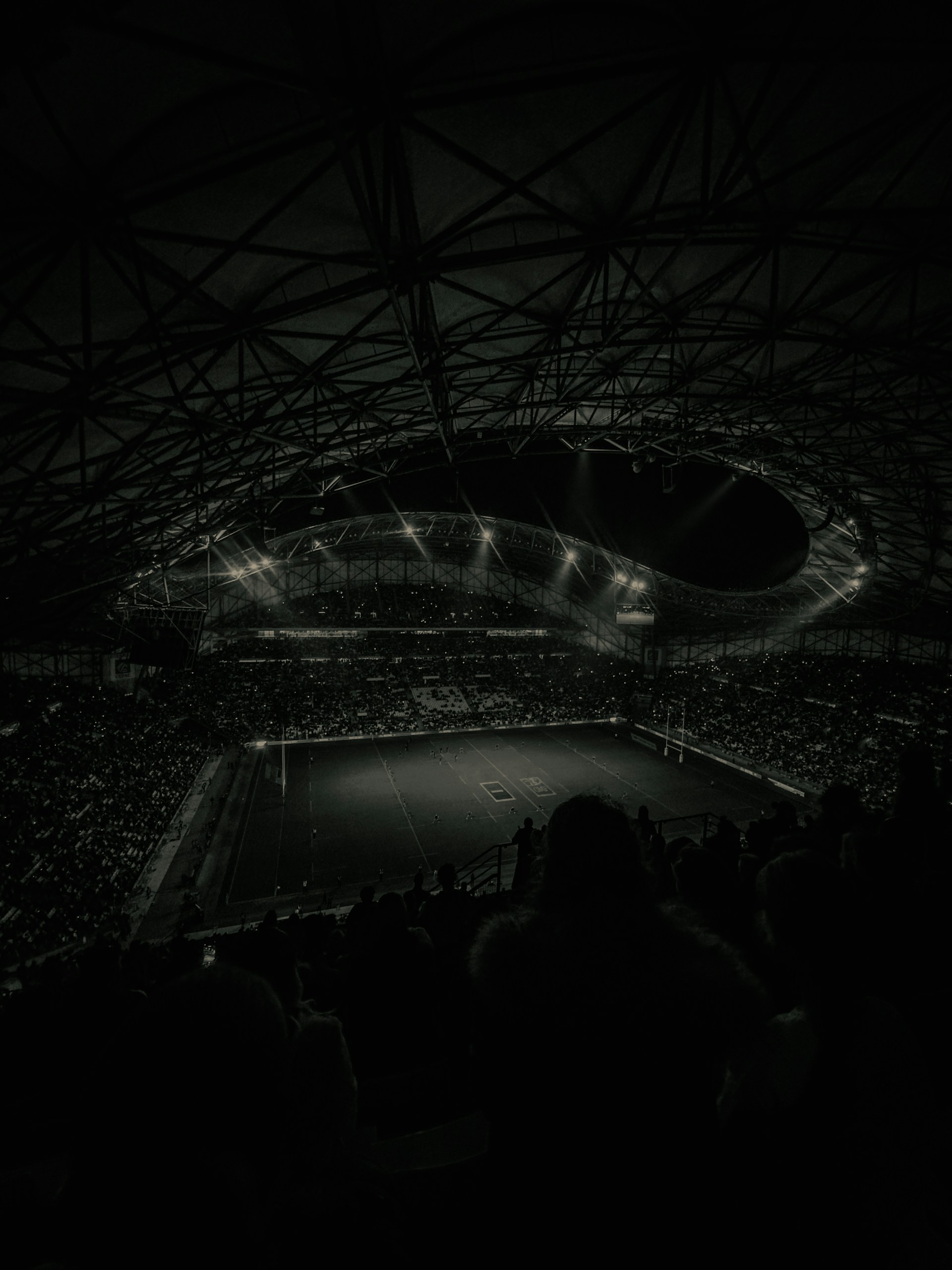 A stadium filled with spectators during a night game.