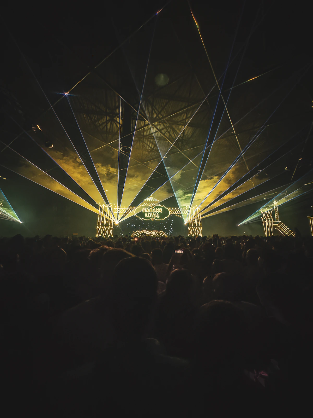 Professional green laser show illuminating a concert crowd